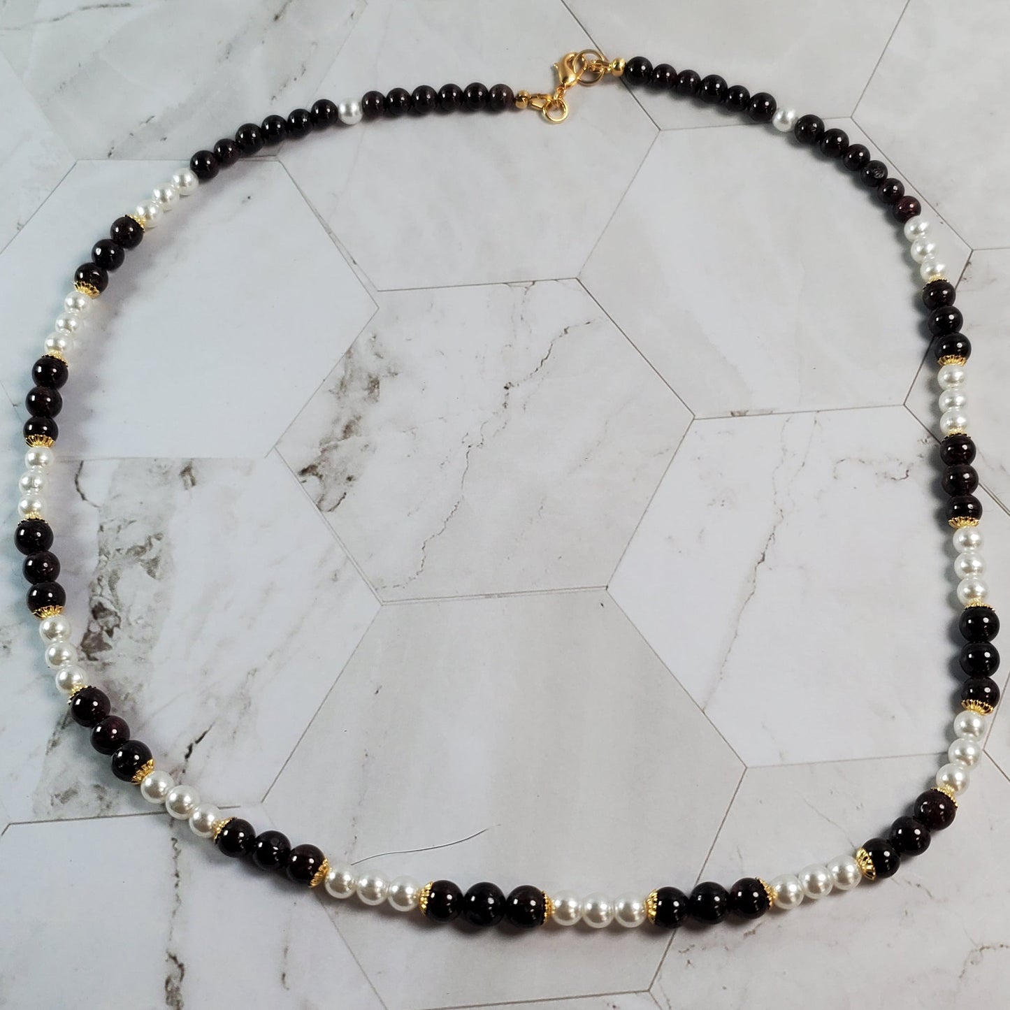 Beaded necklace on a marble surface