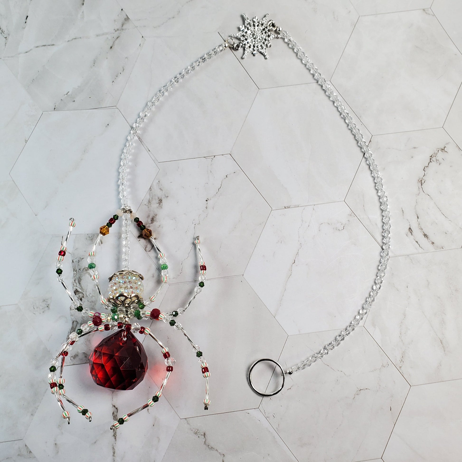 Decorative ornament with a red crystal on a marble surface