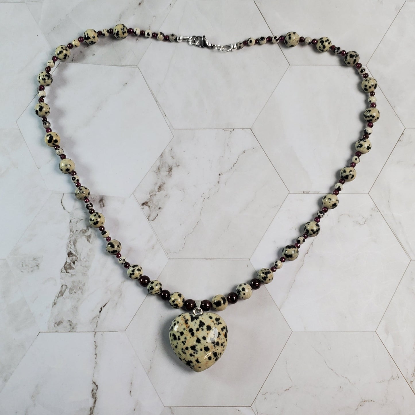 Necklace with a large bead on a marble surface
