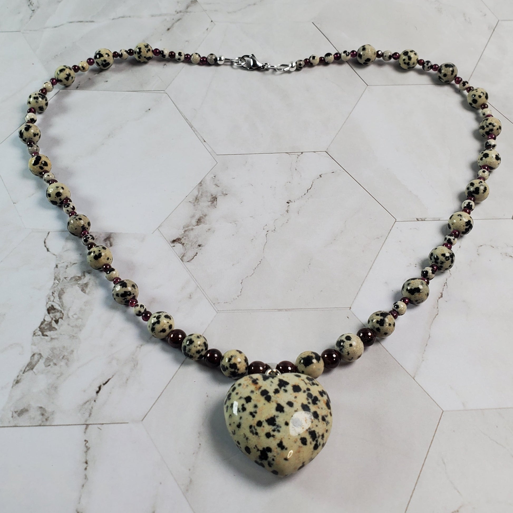 Necklace with a heart-shaped pendant on a marble surface