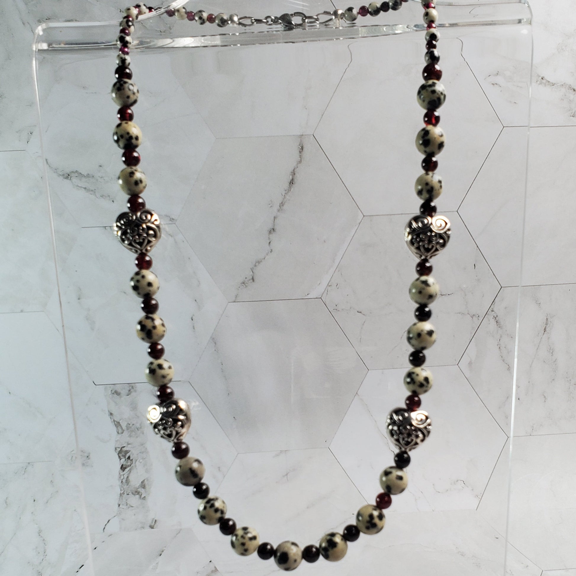 Necklace with black and gold stones on a marble background
