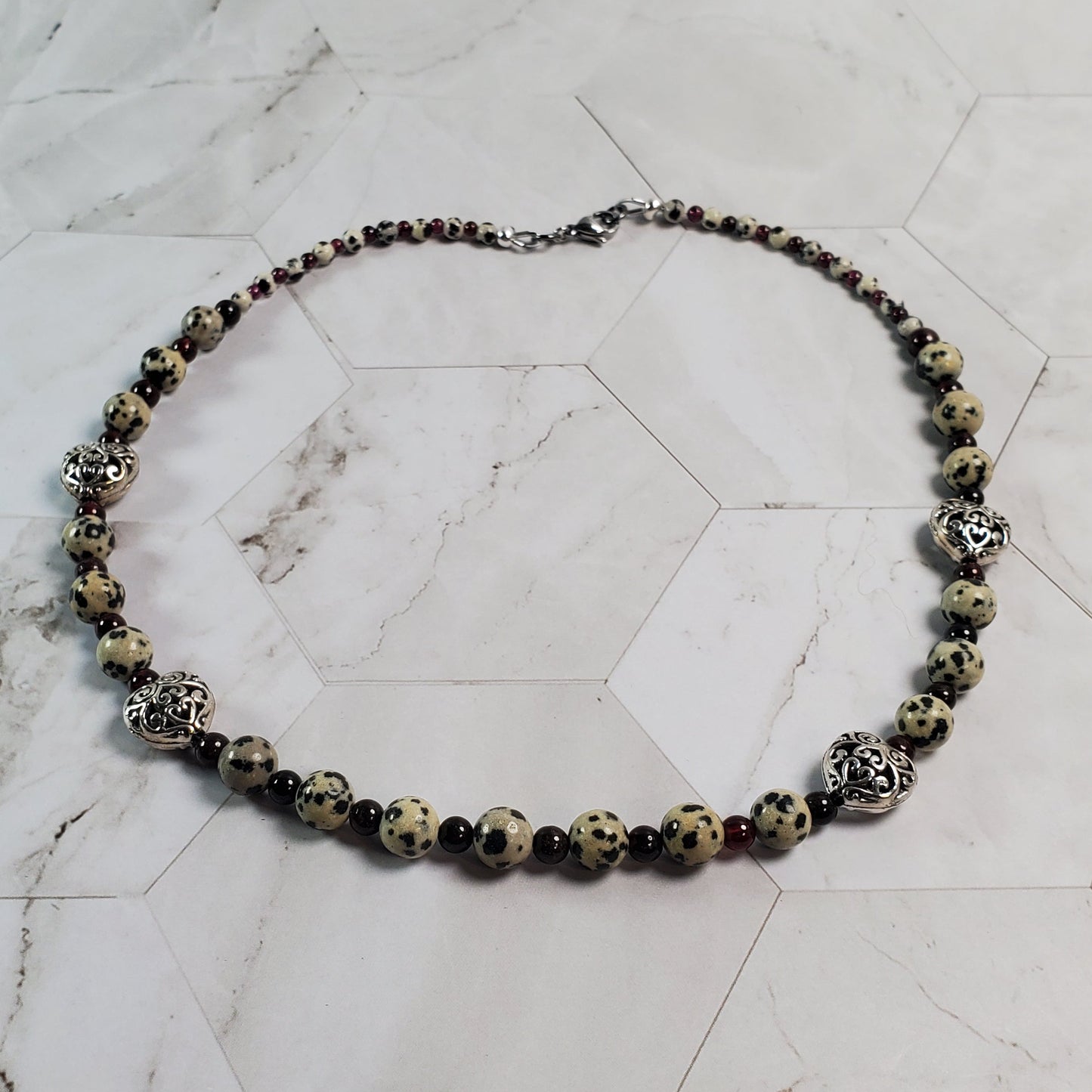 Necklace with gemstone beads on a marble surface