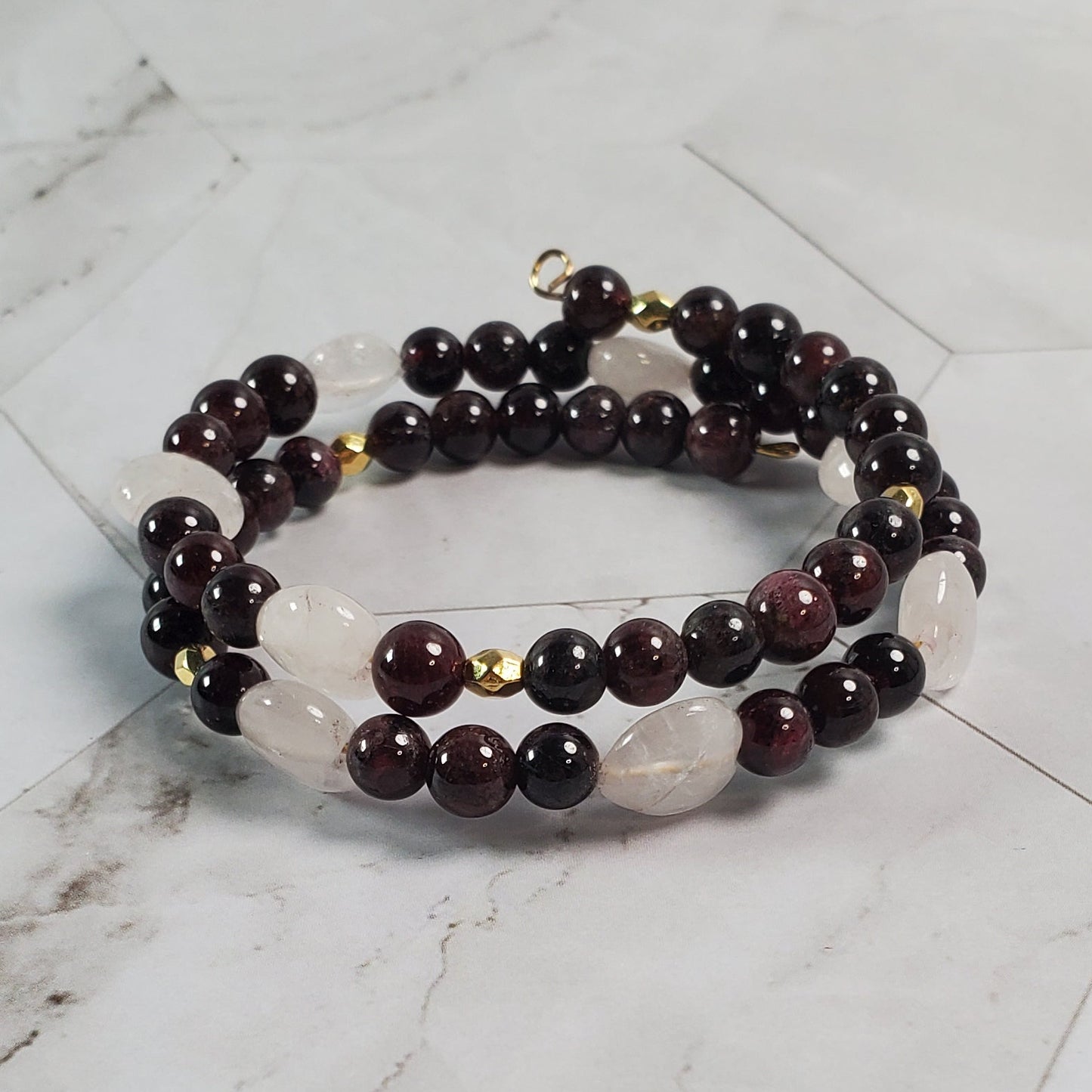 Bracelet with dark beads on a marble surface