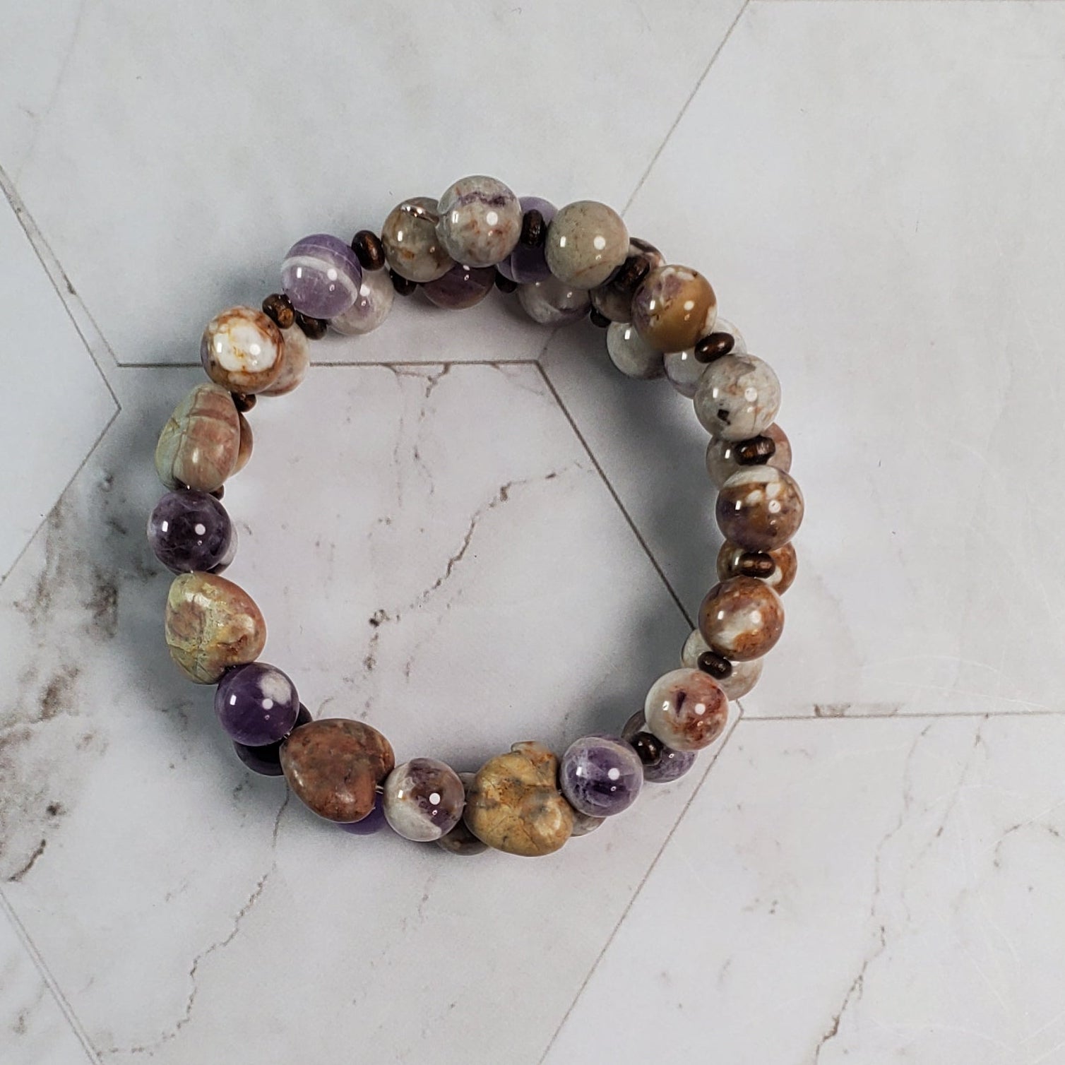 Multicolored beaded bracelet on a marble surface