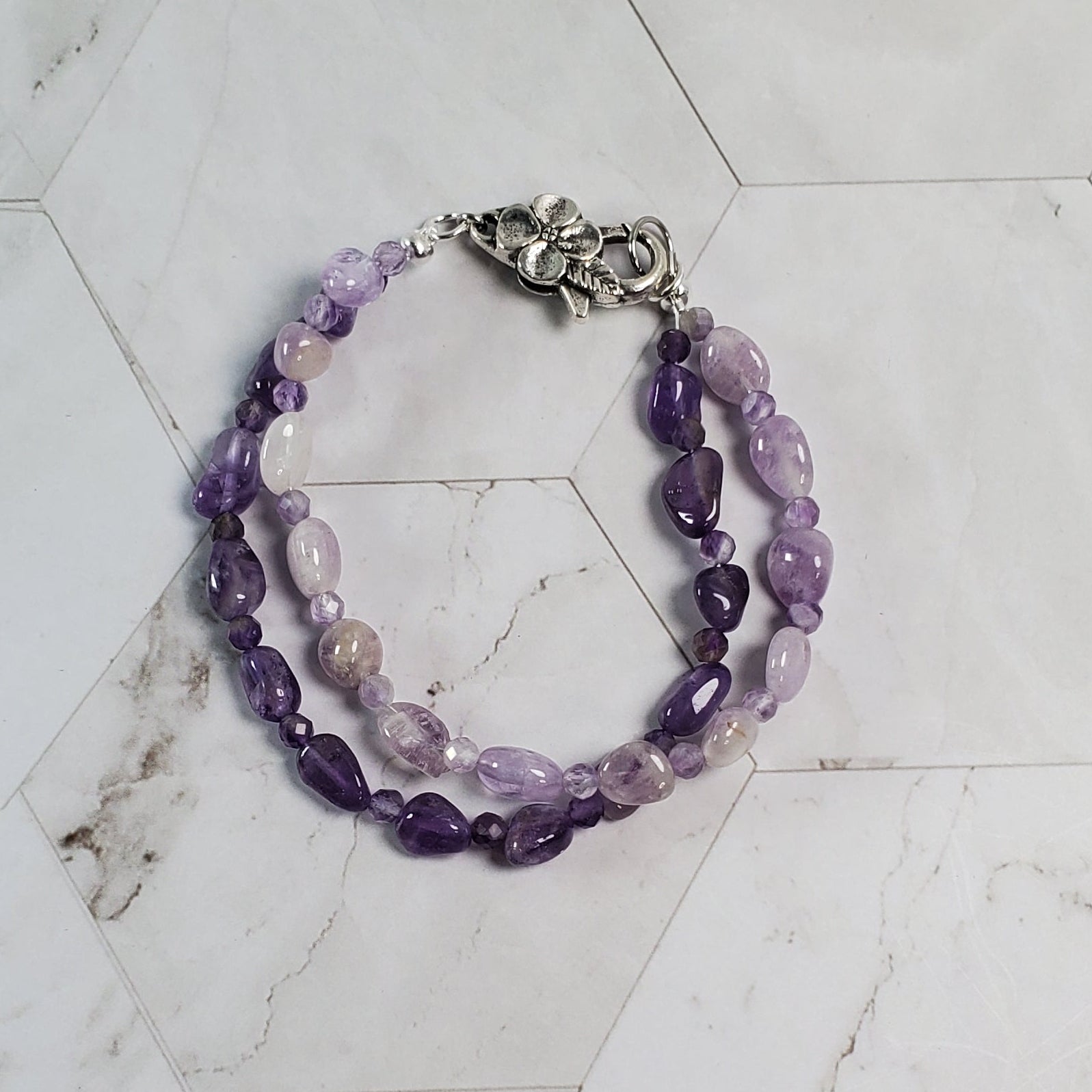 Purple beaded bracelet on a marble surface