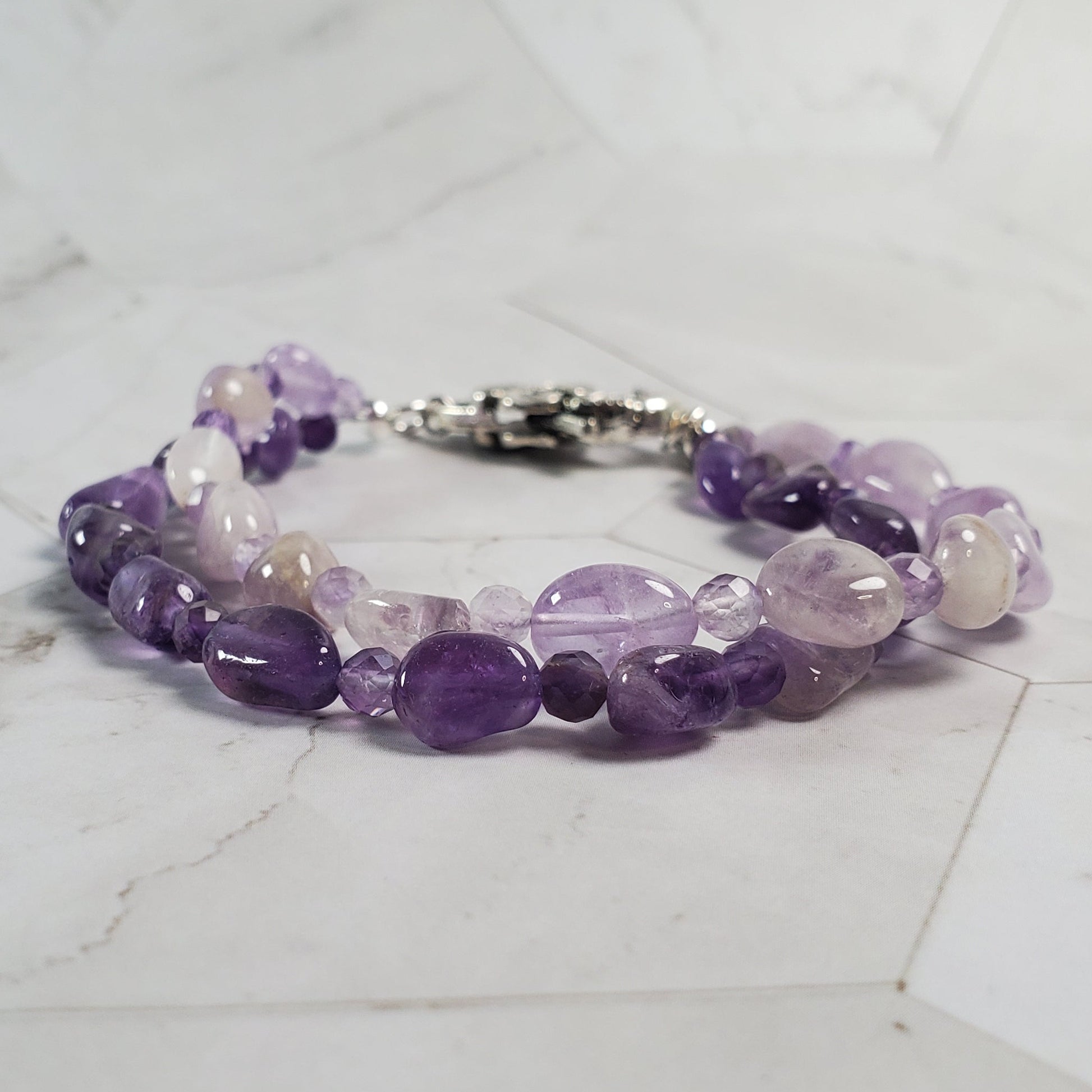 Purple beaded bracelet on a marble surface