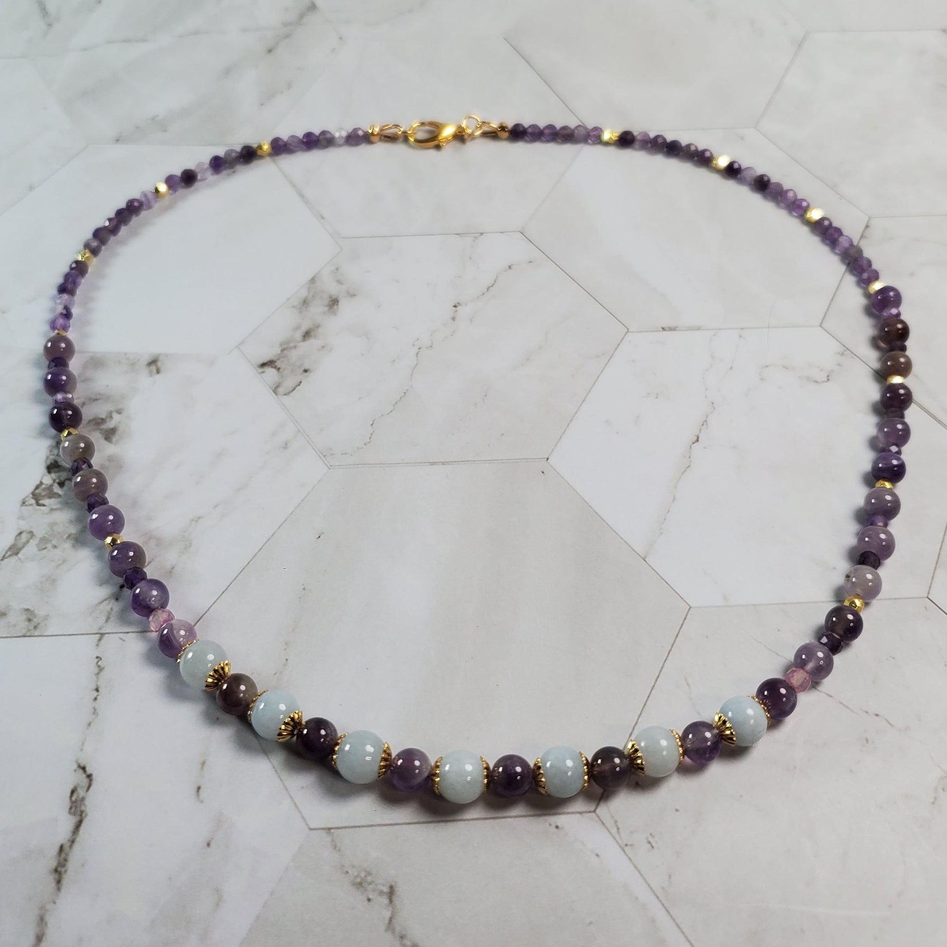 Beaded necklace on a marble surface