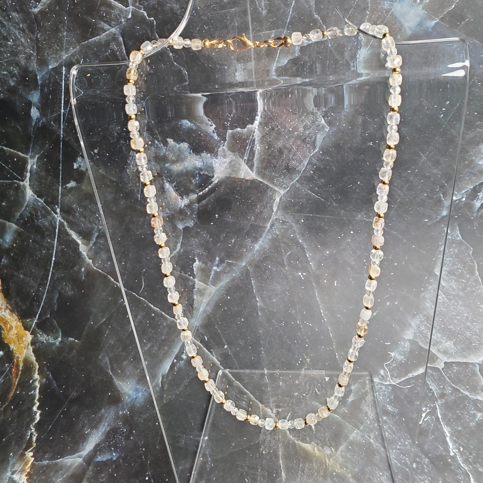 Necklace with small stones on a marble surface