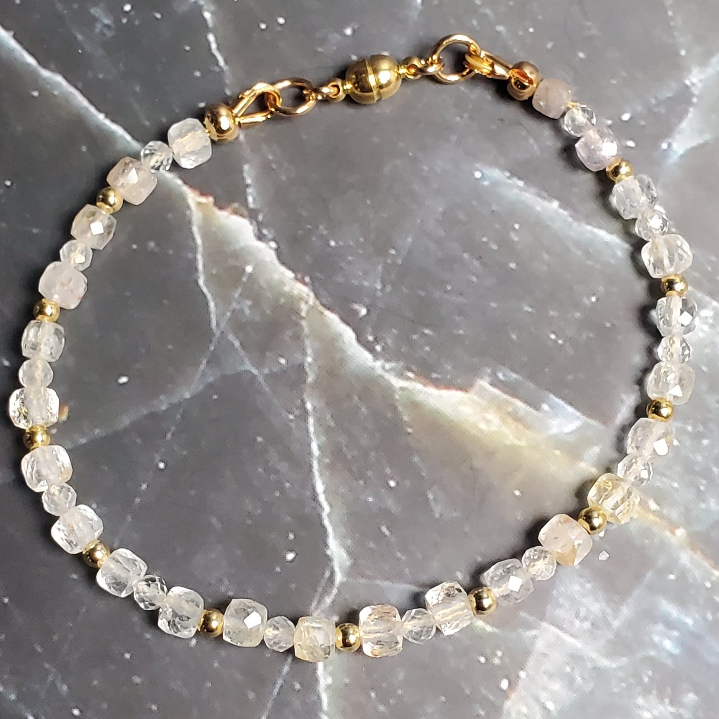 Bracelet with small stones on a dark marble surface