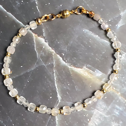 Bracelet with small stones on a dark marble surface