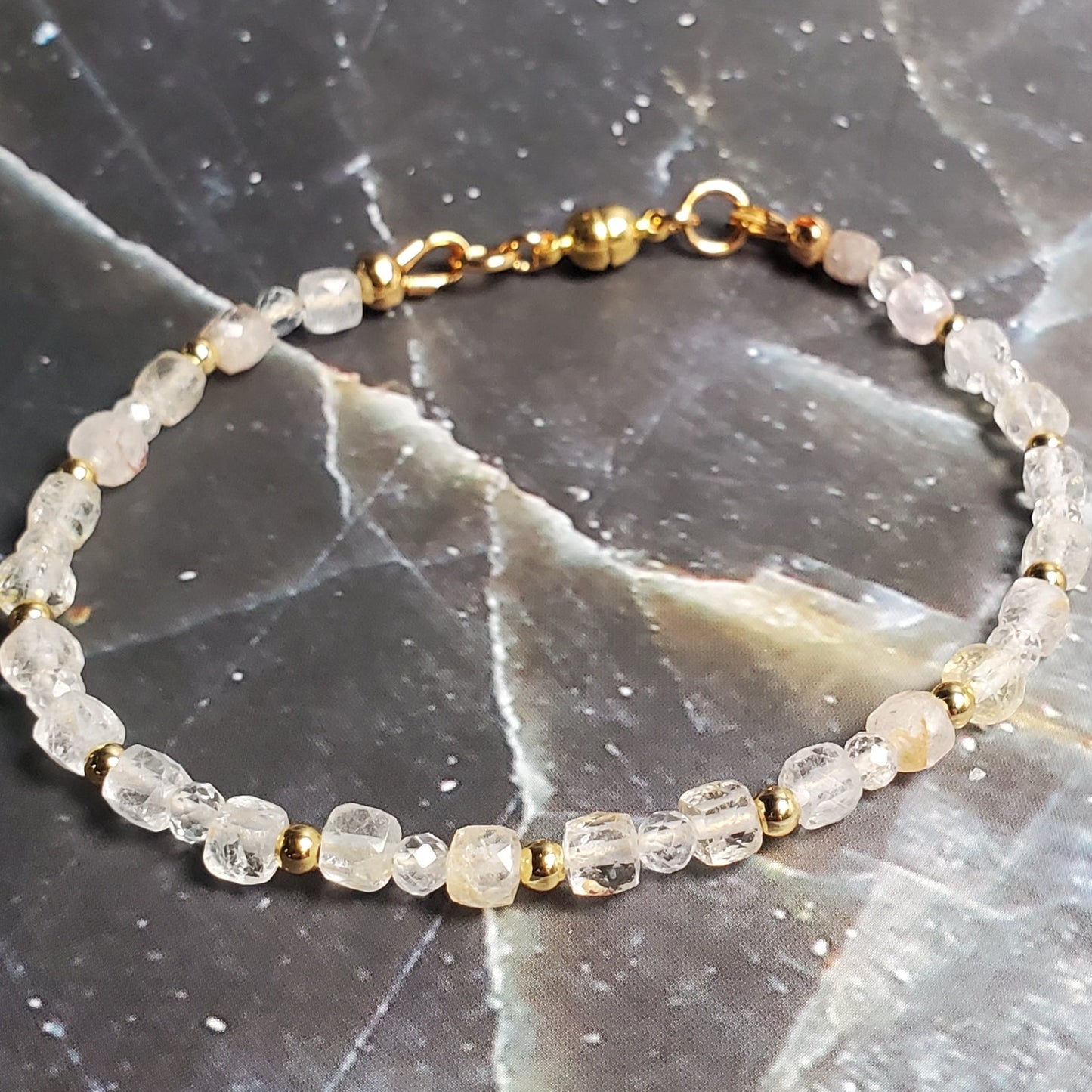 Bracelet with small stones on a dark marble surface