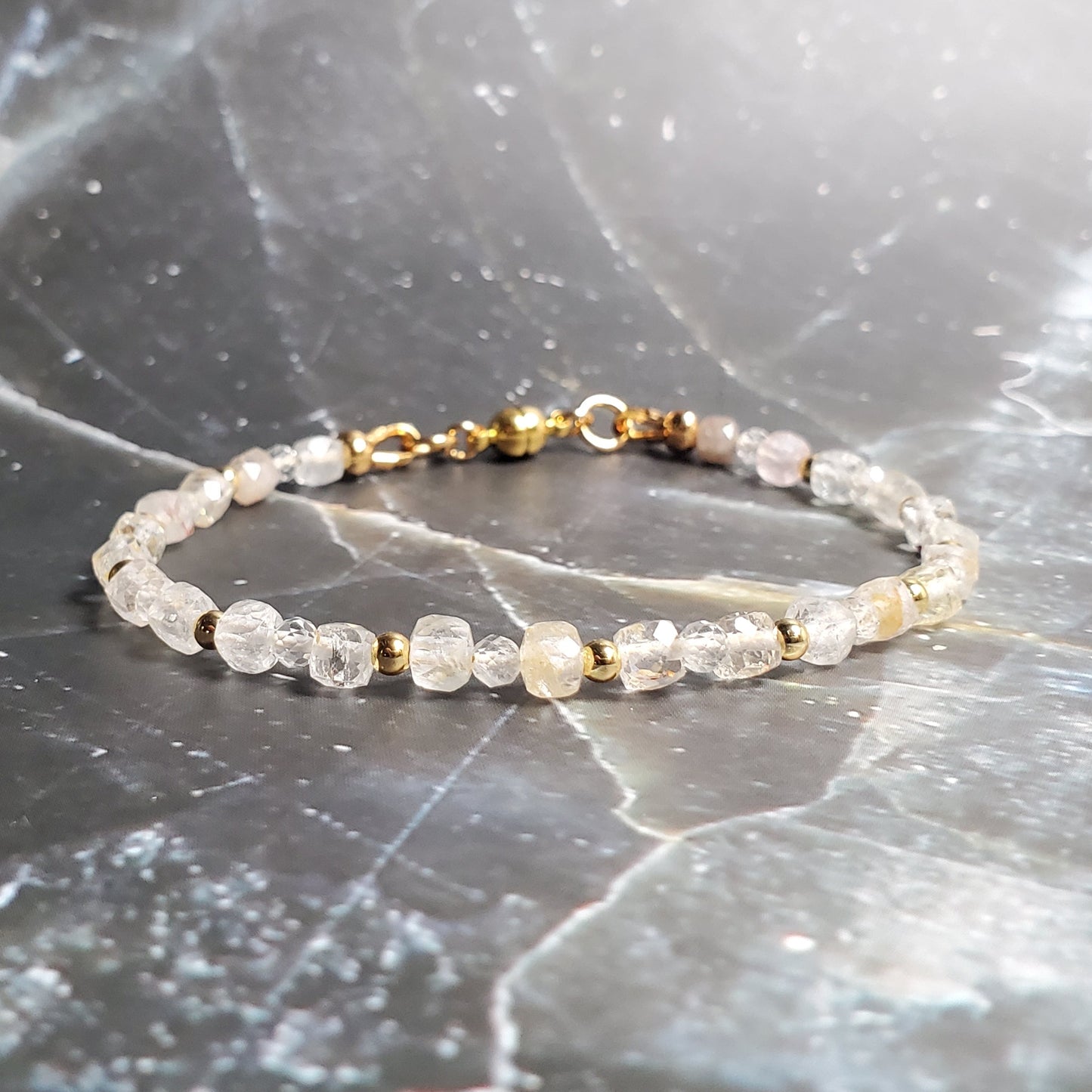 Bracelet with small beads on a gray marble surface