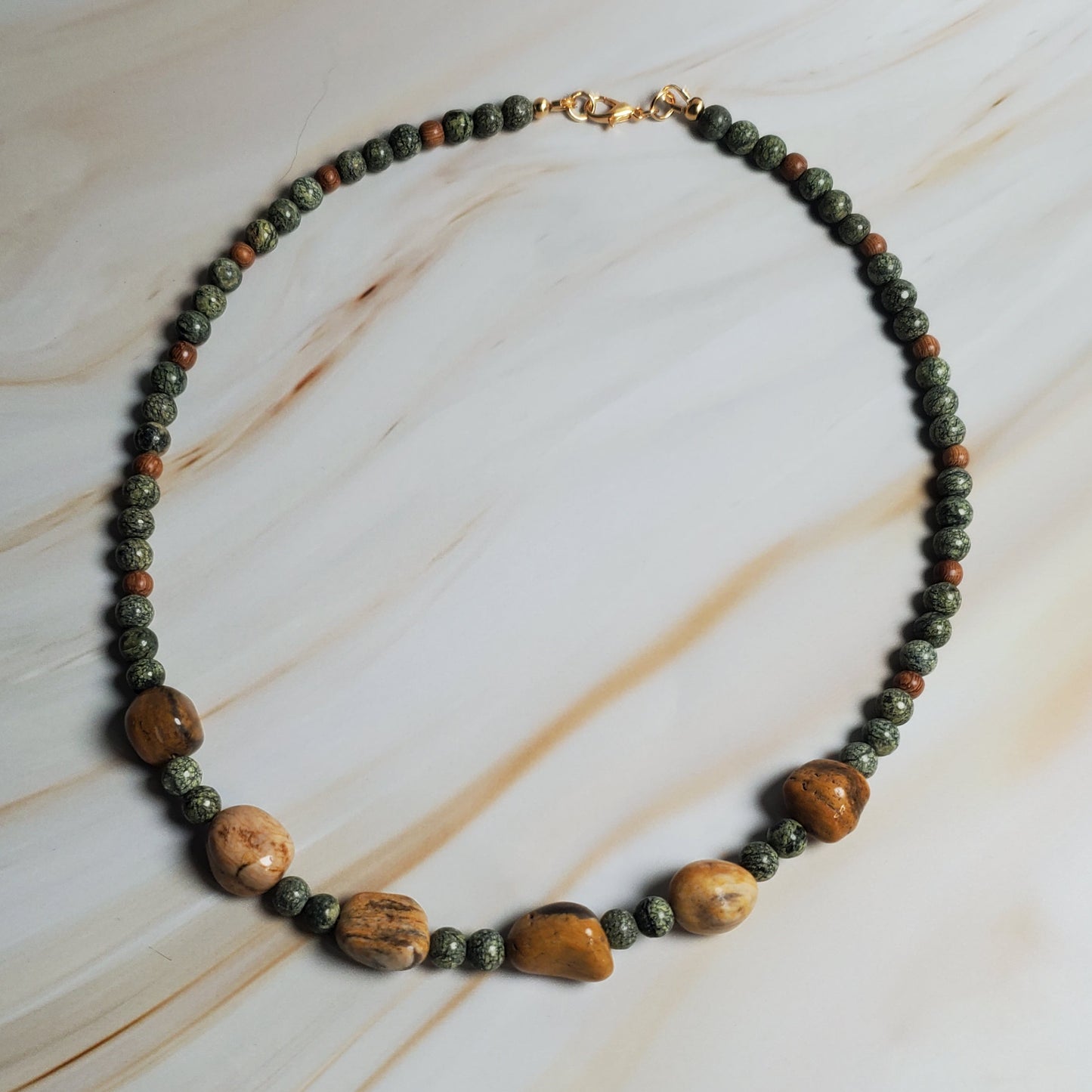 Necklace with beads on a marble surface