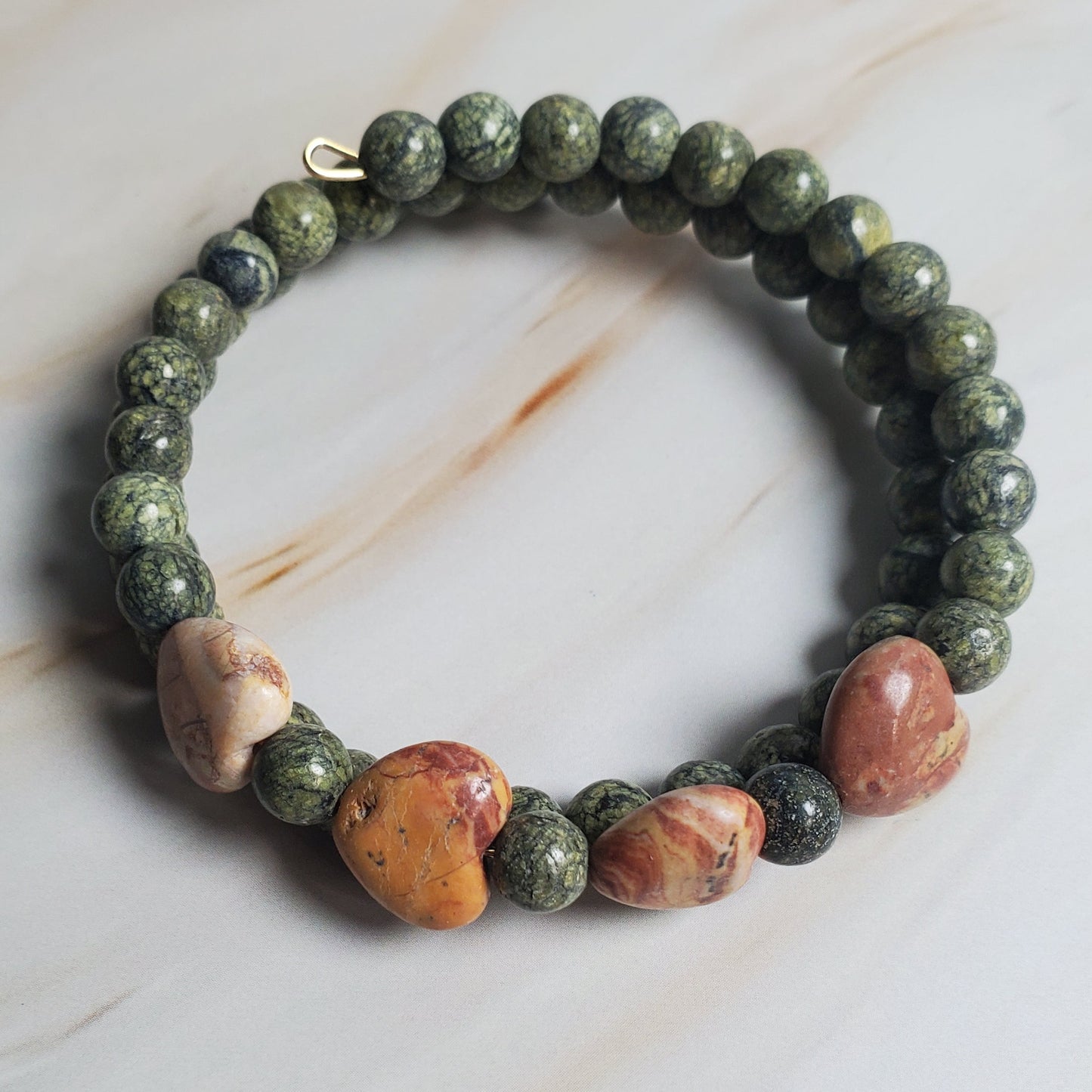Bracelet with multicolored beads on a marble surface