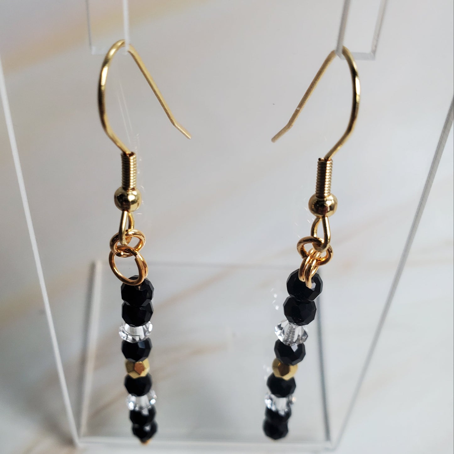 Pair of beaded earrings with gold hooks on a white background