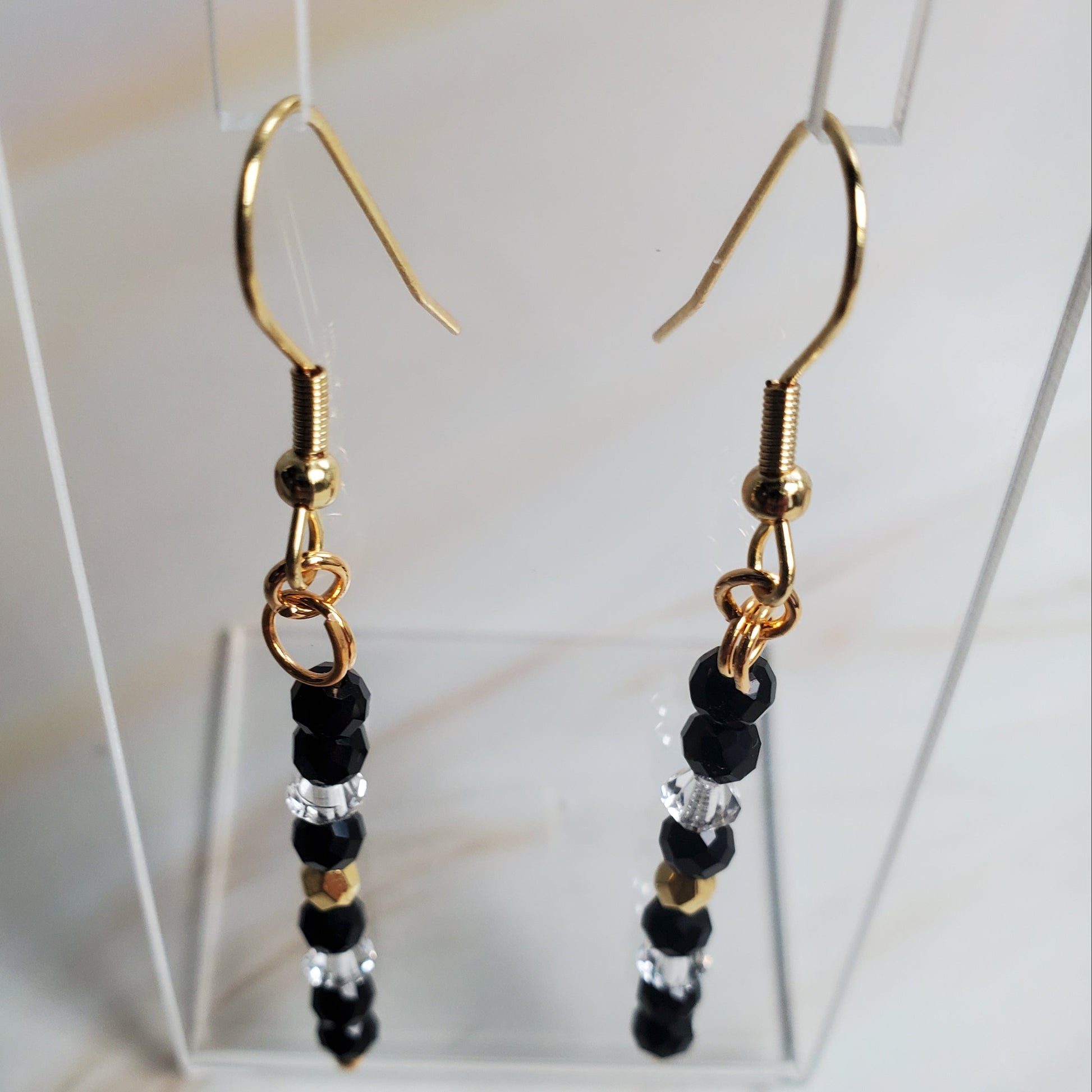 Pair of beaded earrings with gold hooks on a white background