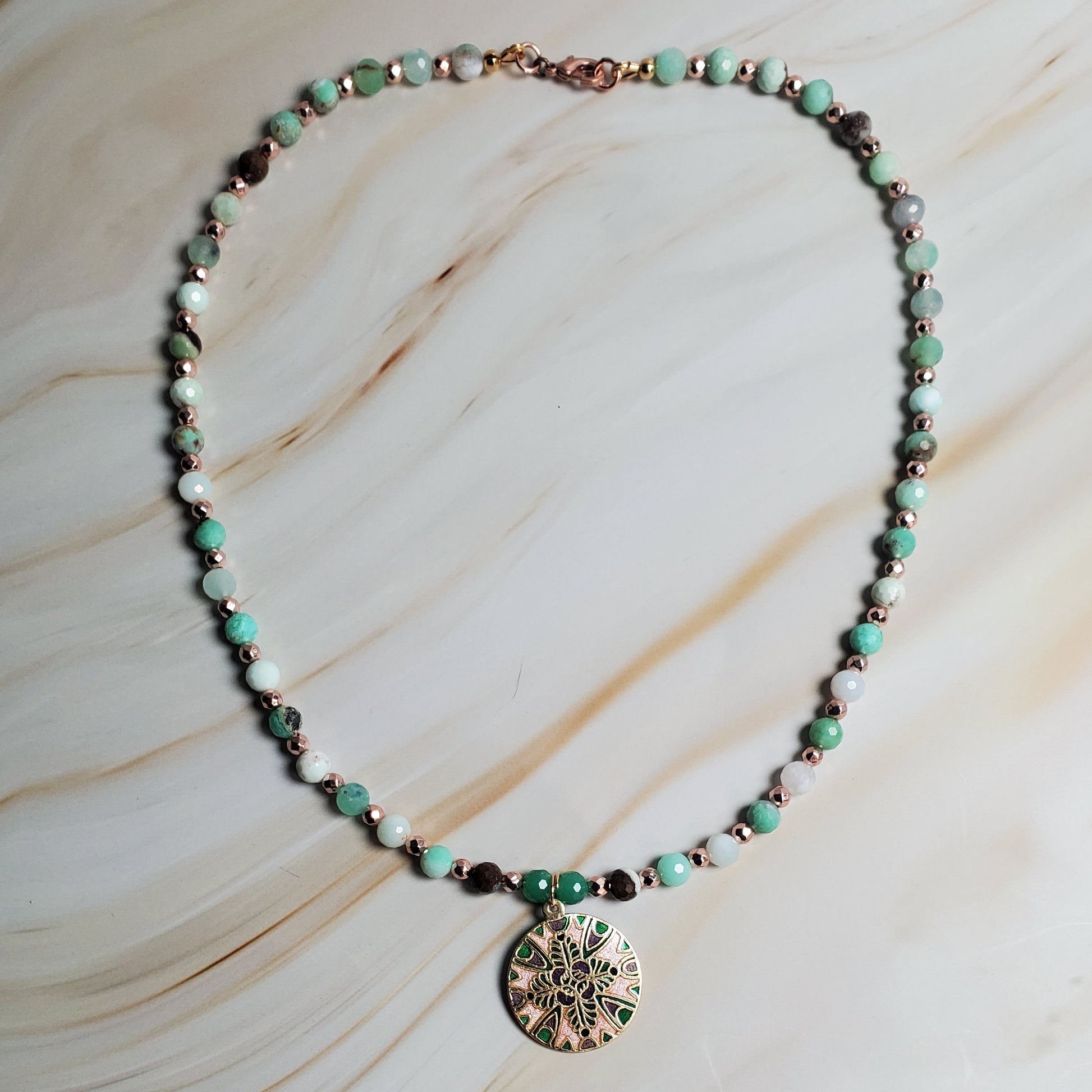 Necklace with a pendant on a marble surface