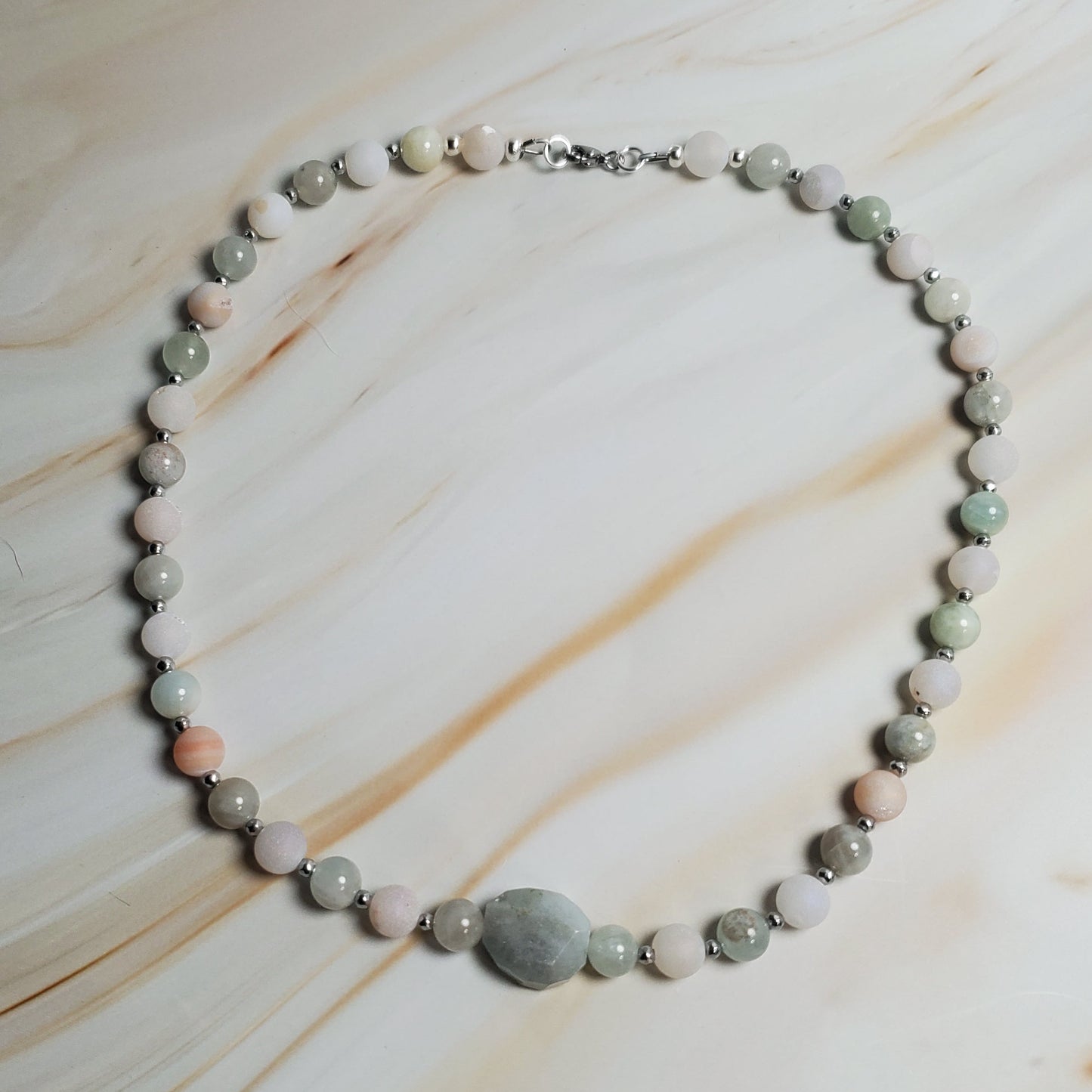 Necklace with round beads on a marble surface