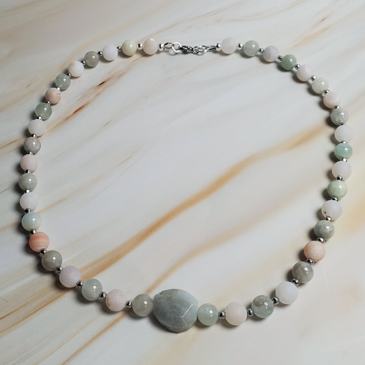 Necklace with round beads on a marble surface