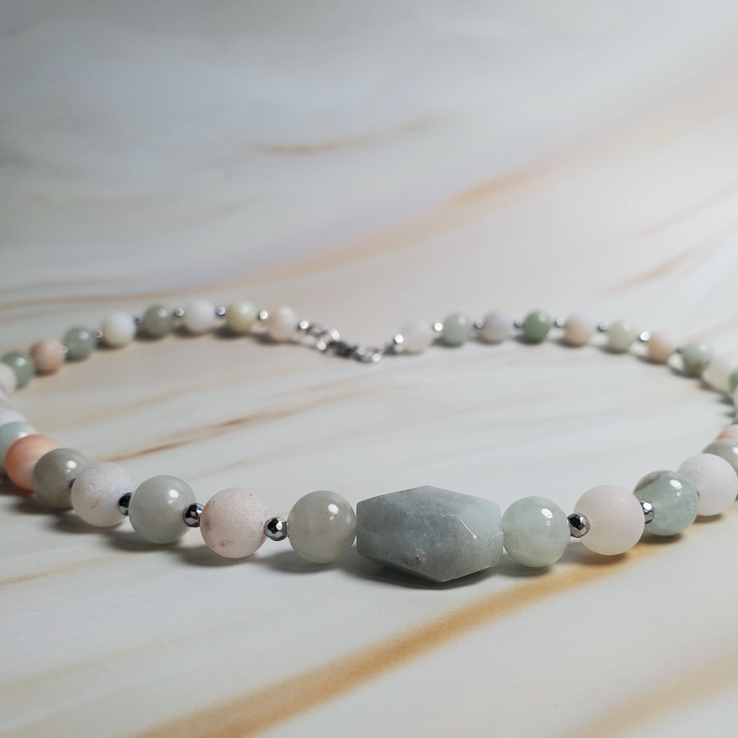 Beaded necklace with natural stones on a marble surface