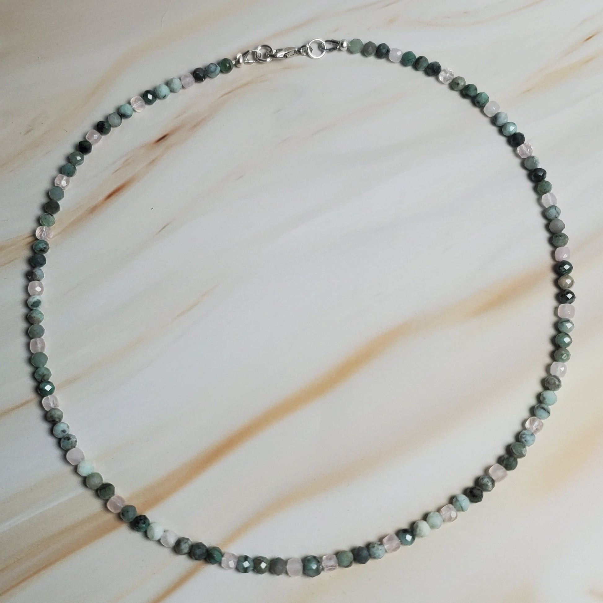 Necklace with small beads on a light fabric background