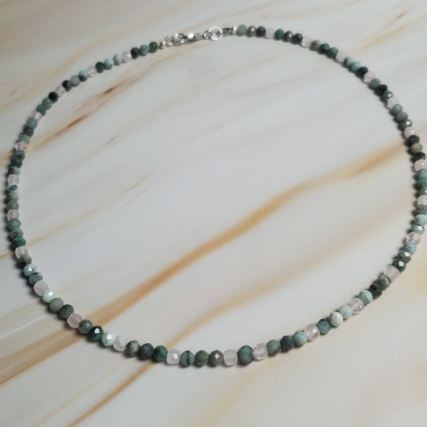Beaded necklace on a light wood surface