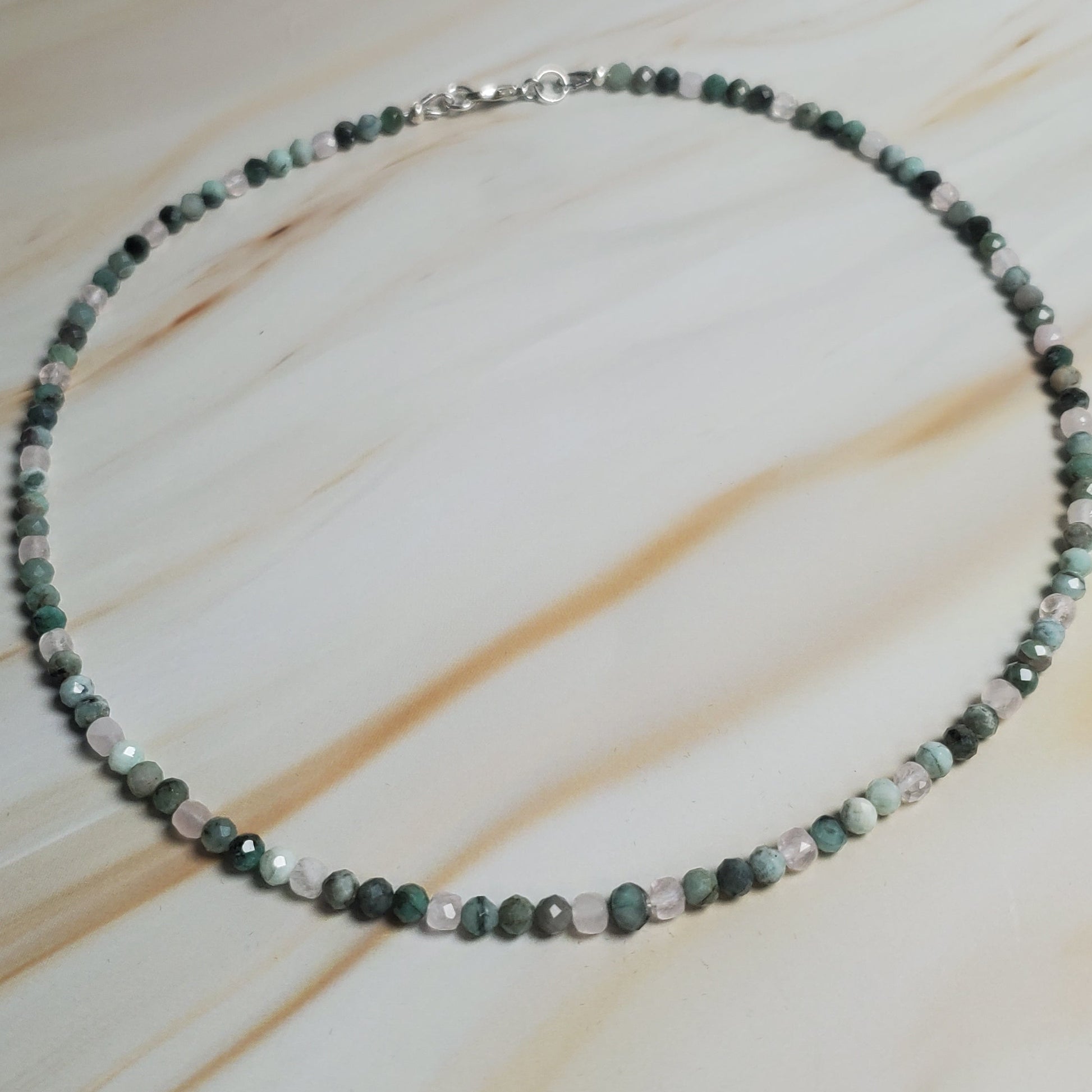 Beaded necklace on a light wood surface