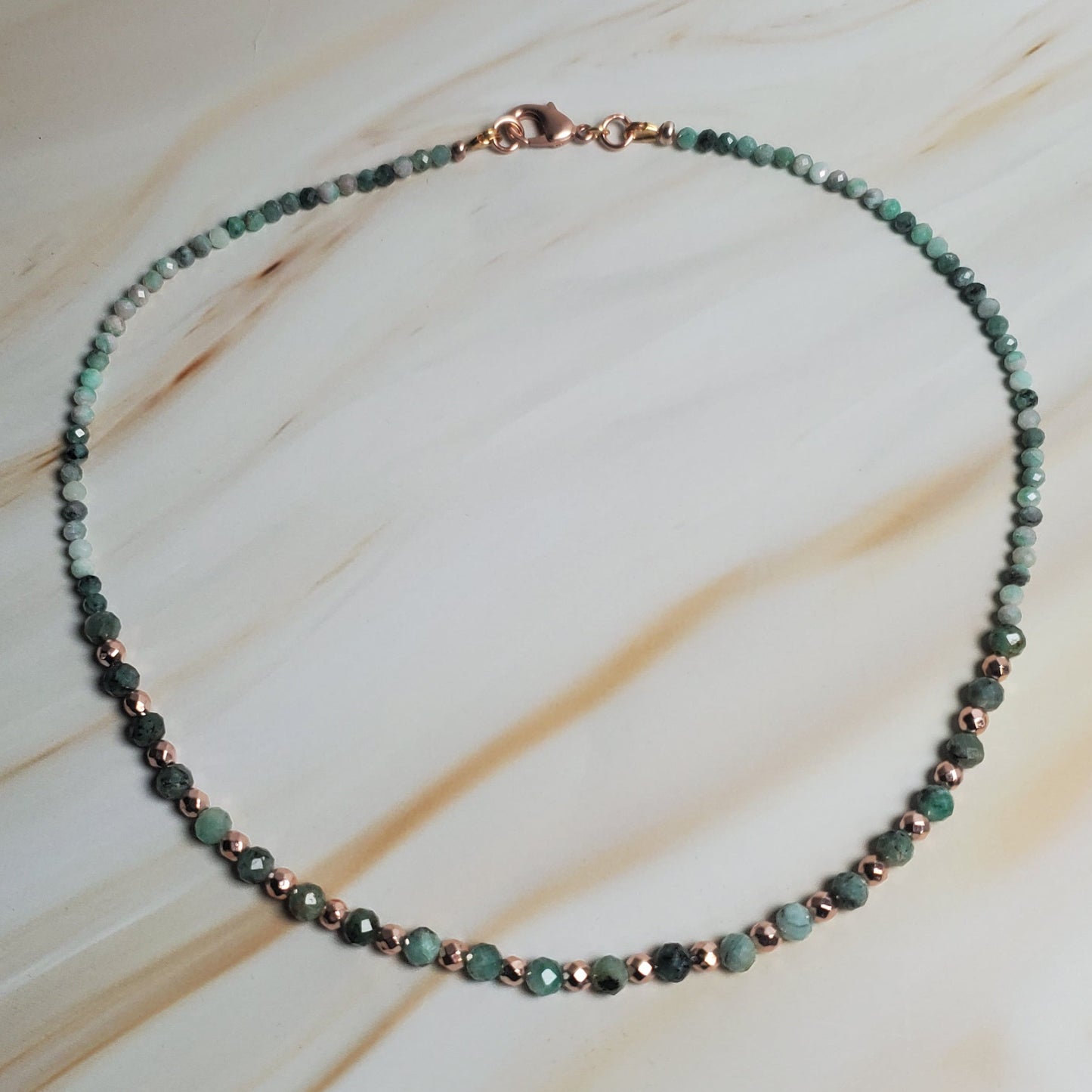 Beaded necklace on a textured beige surface