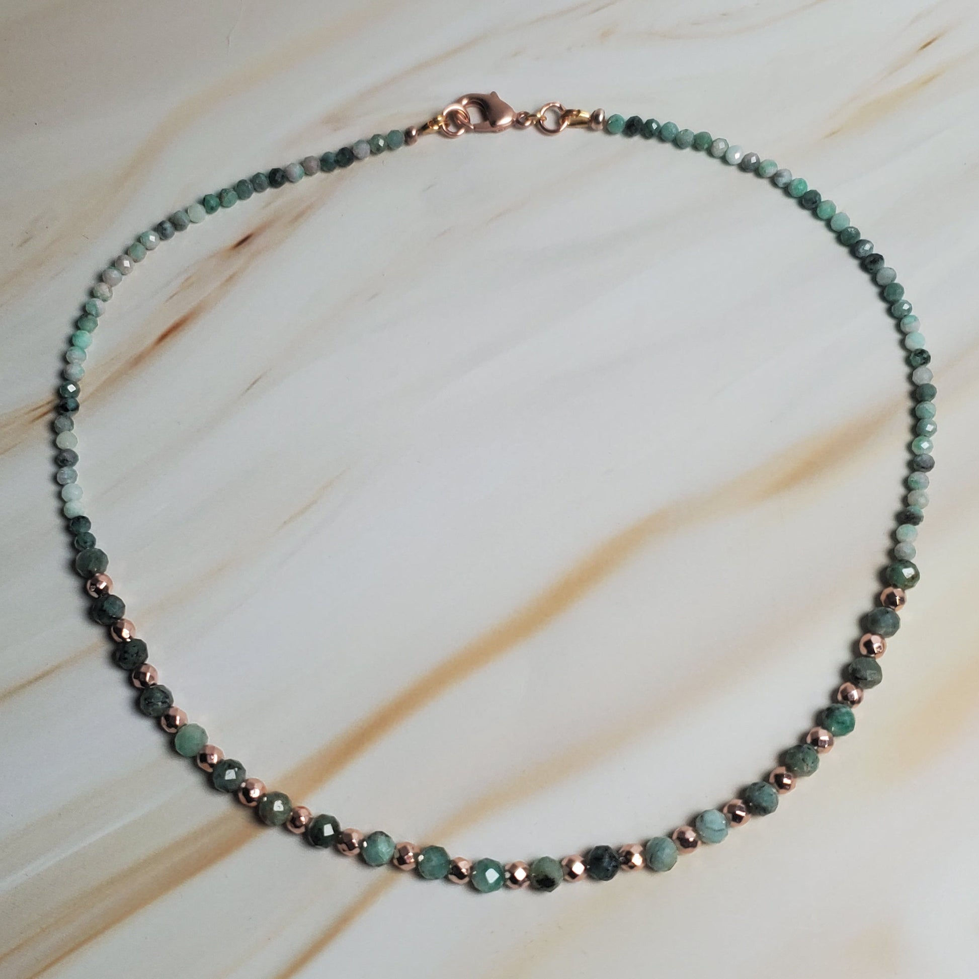 Beaded necklace on a textured beige surface