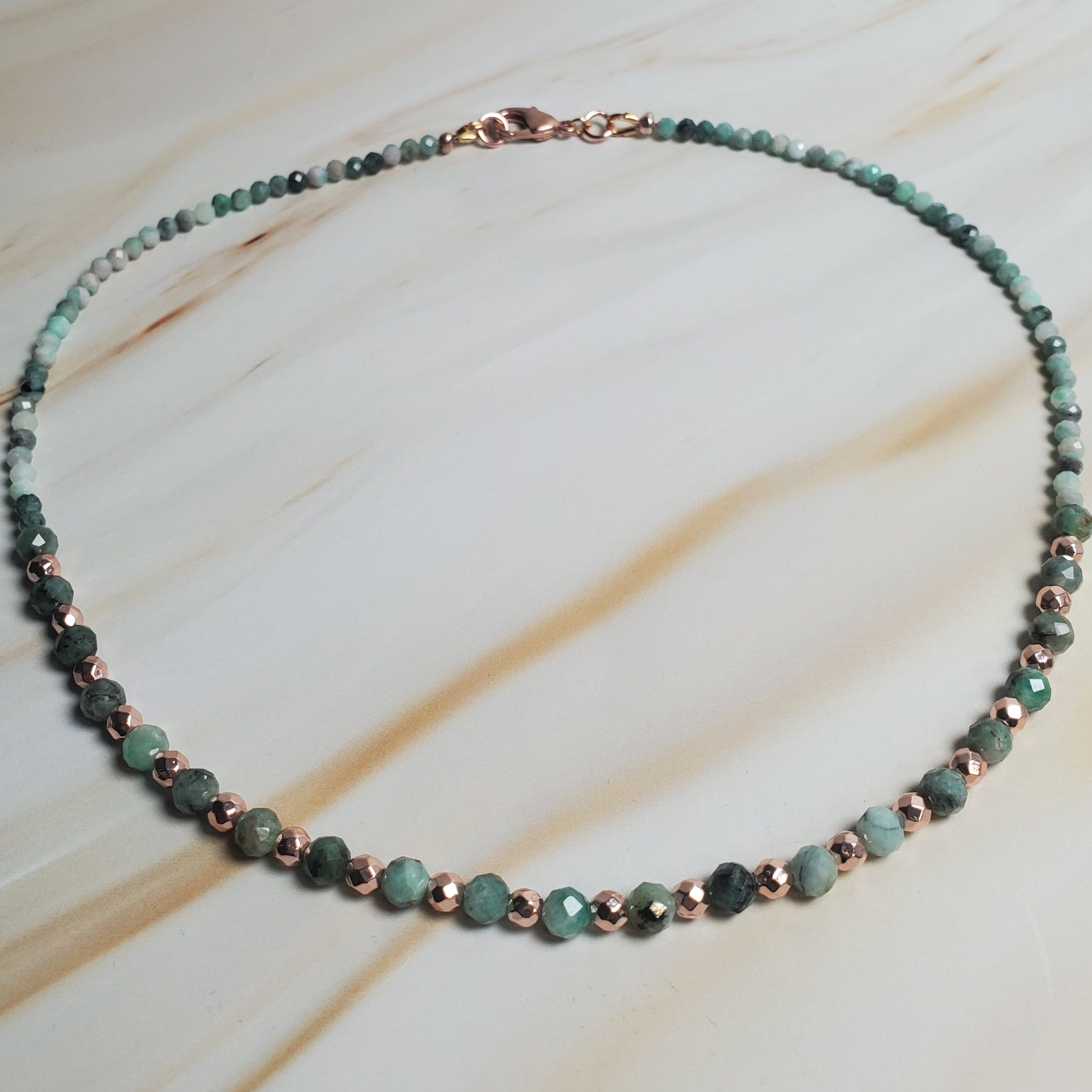 Necklace with green beads on a light wooden surface
