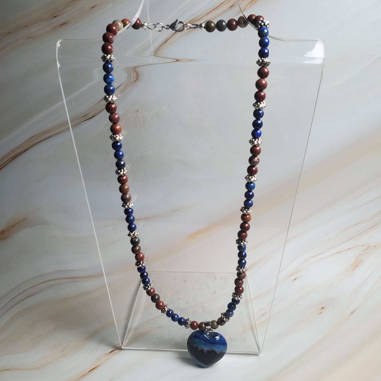 Necklace with multicolored beads on a marble surface