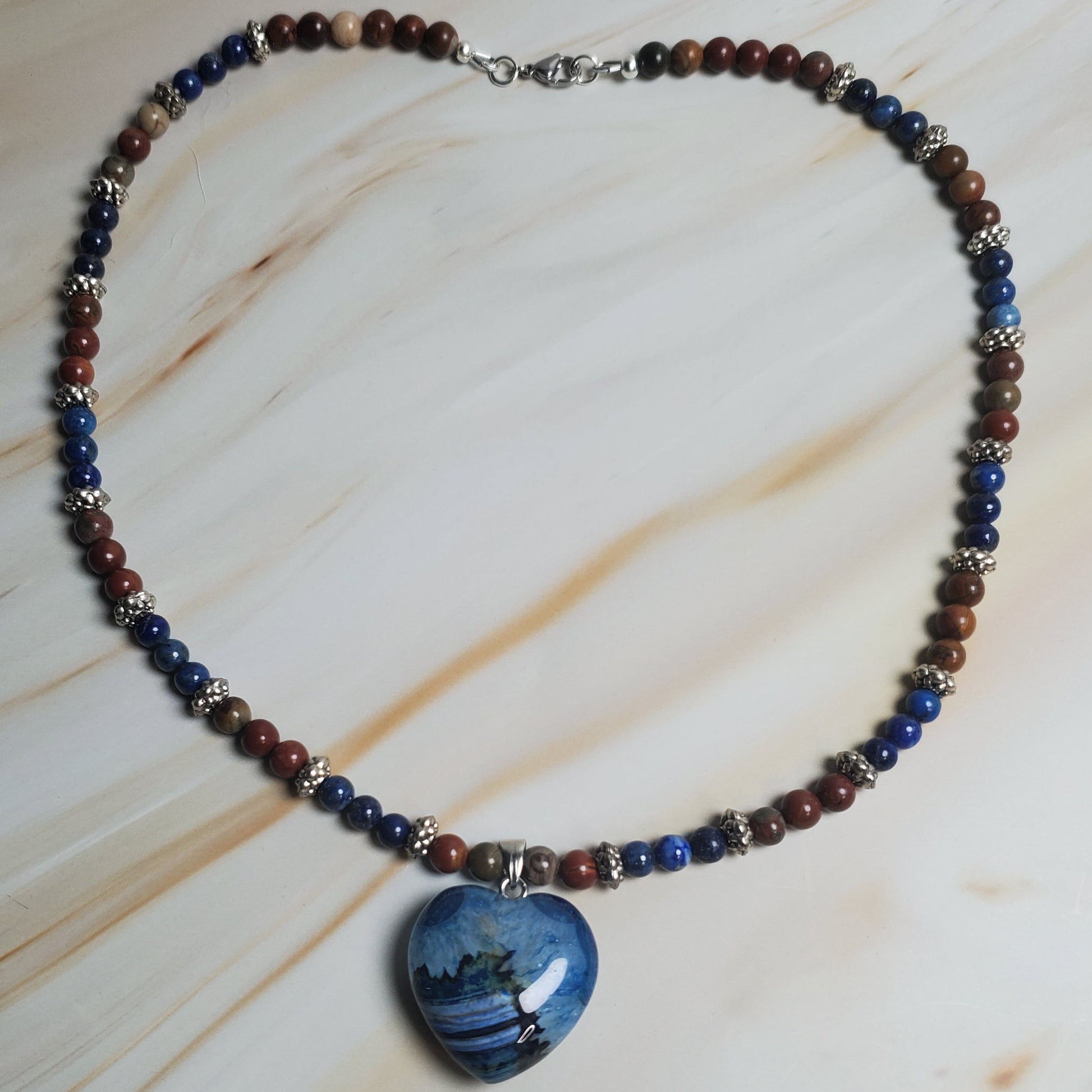 Necklace with blue and brown beads on a light wood surface