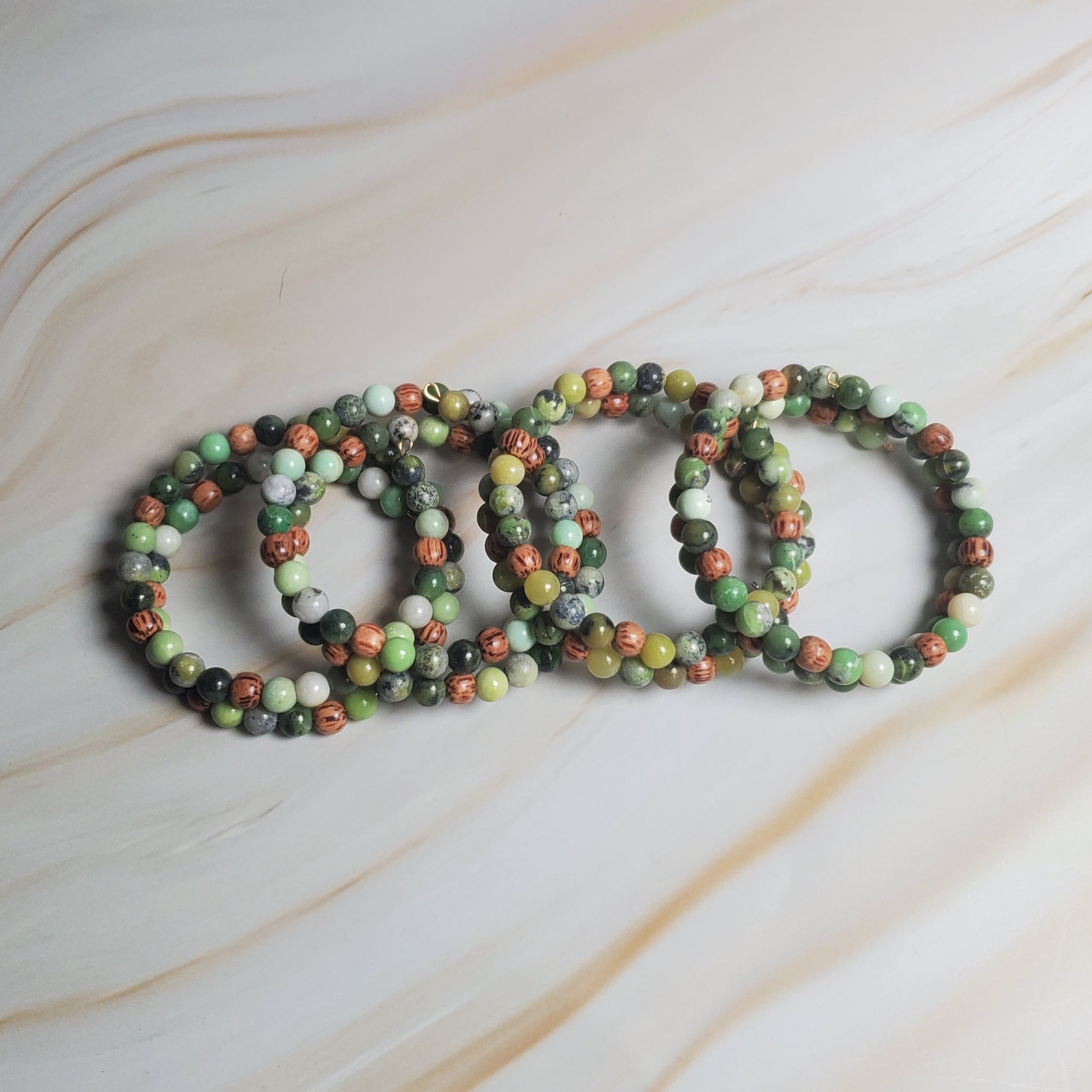 Set of beaded bracelets on a marble surface