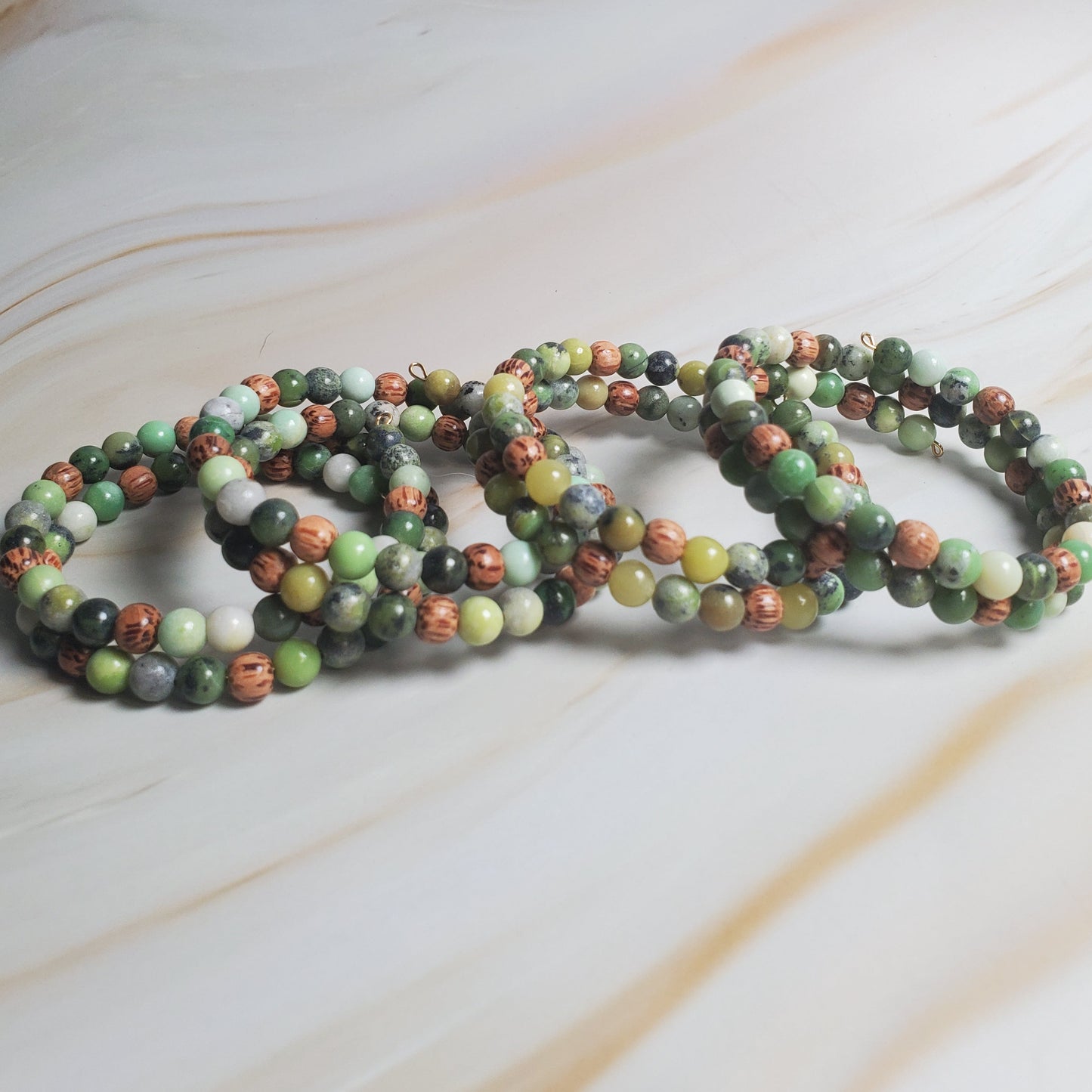 Multicolored beaded bracelets on a light marble surface
