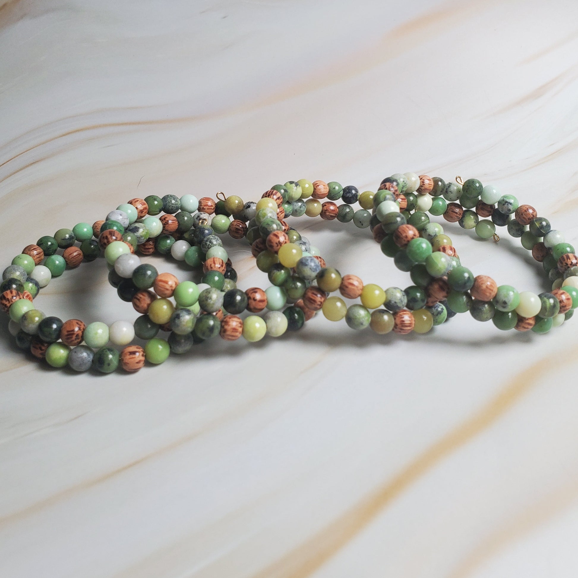 Multicolored beaded bracelets on a light marble surface