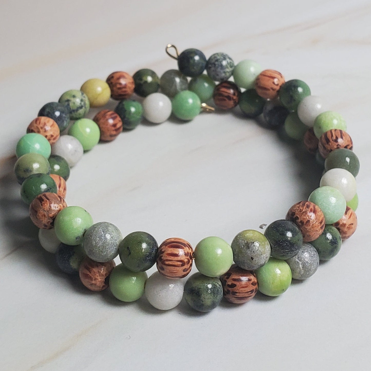 Multicolored beaded bracelet on a light marble surface