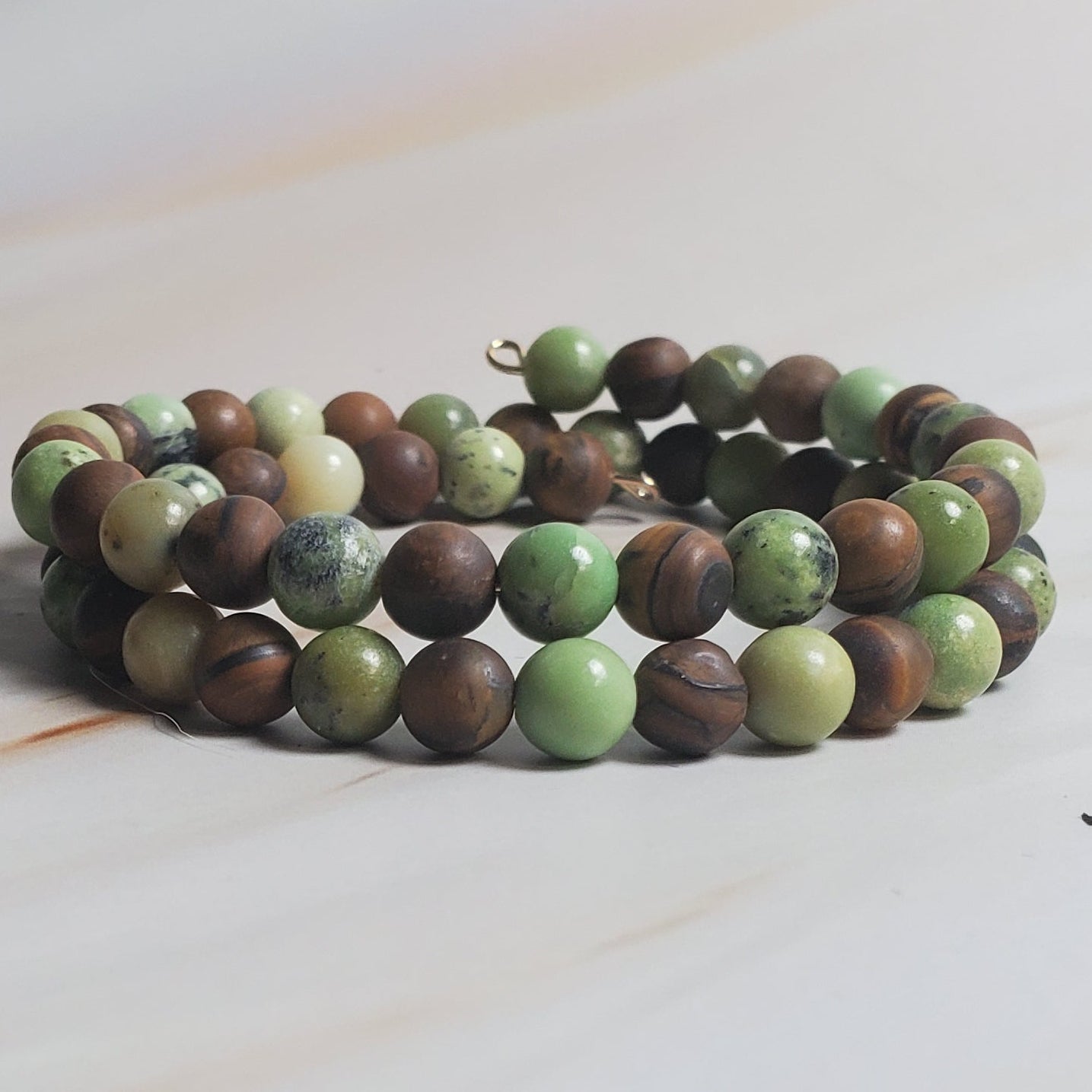 Multicolored beaded bracelet on a light wood surface