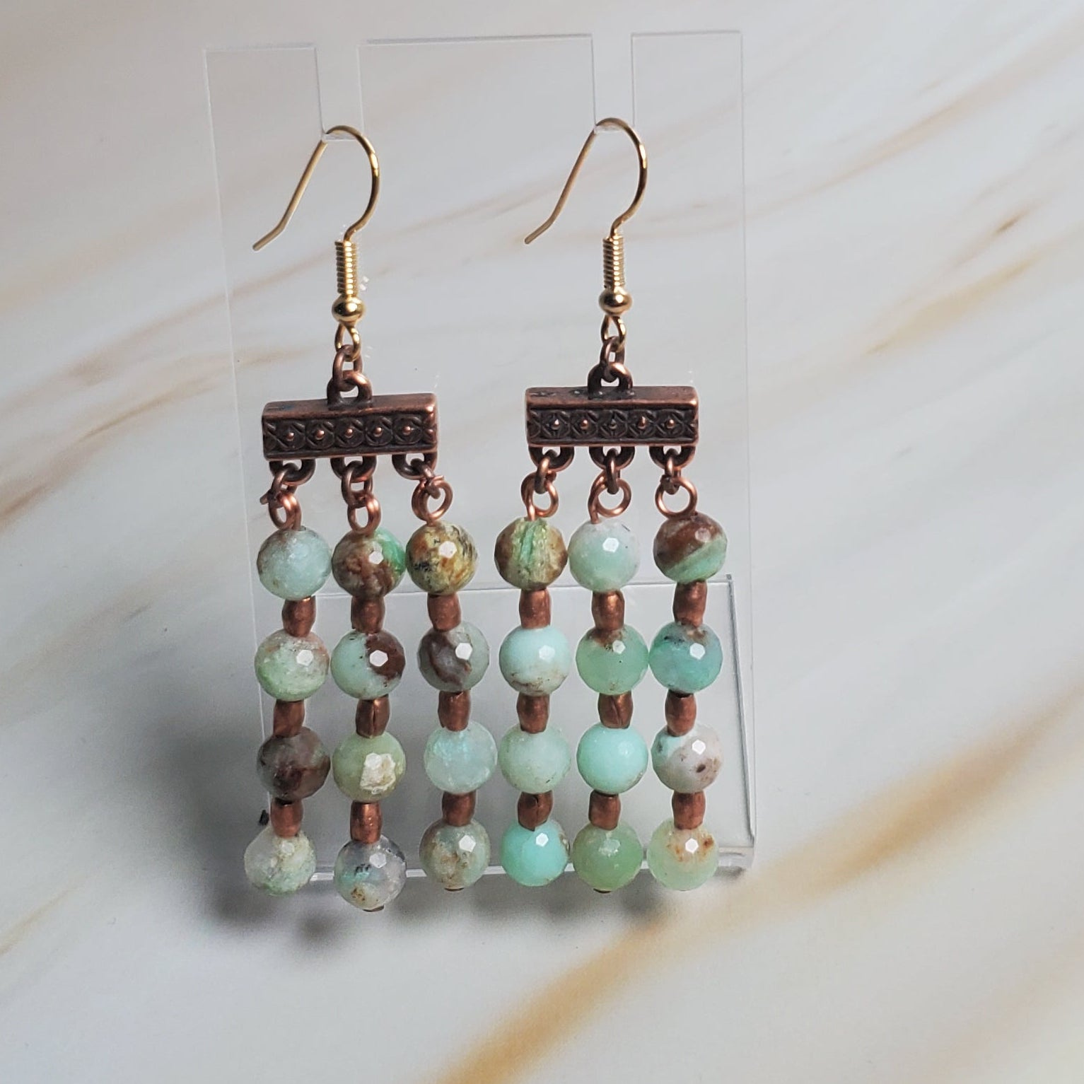 Beaded earring on a light fabric background