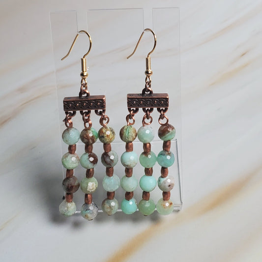 Beaded earring on a light fabric background