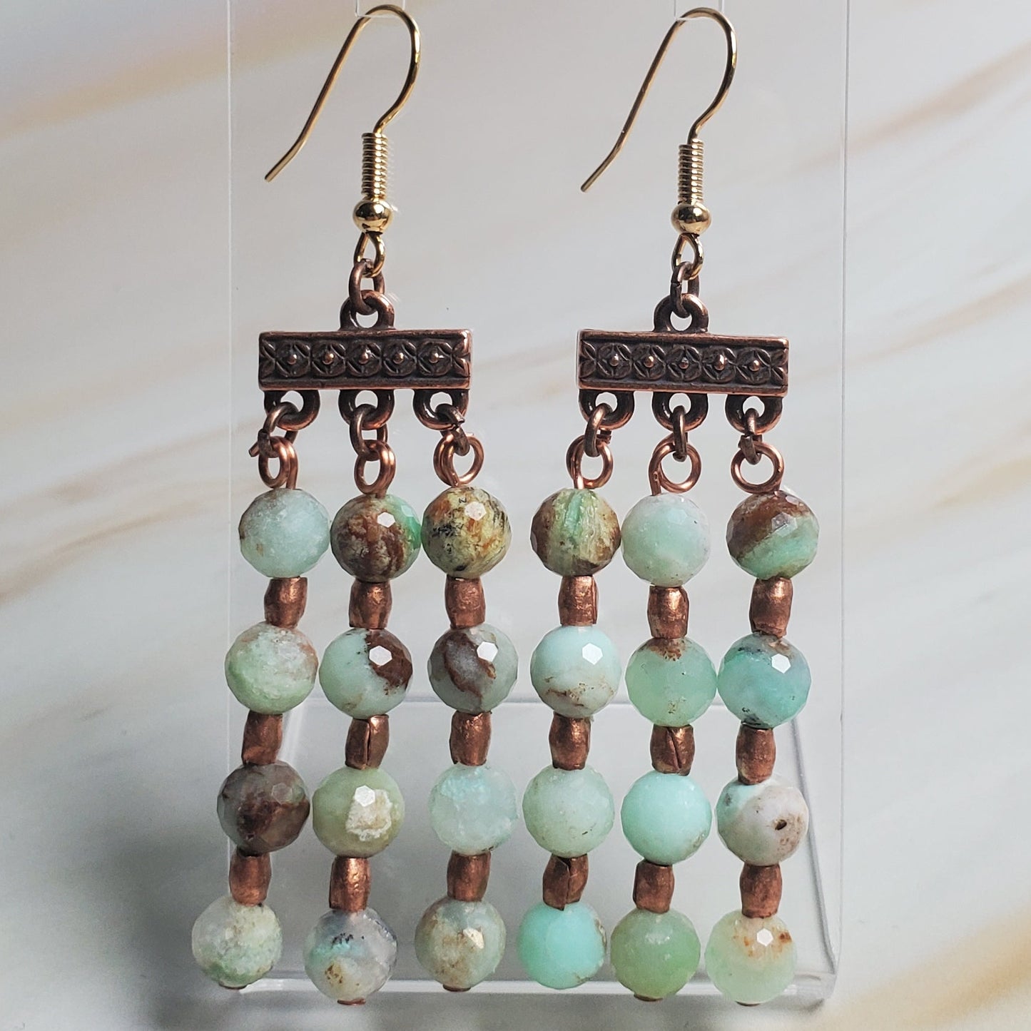 Beaded earrings on a white fabric background