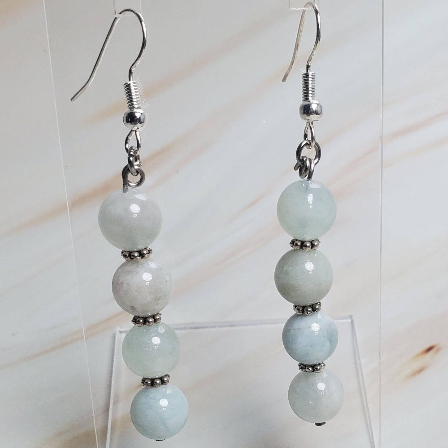 Pair of earrings with beads on a light background