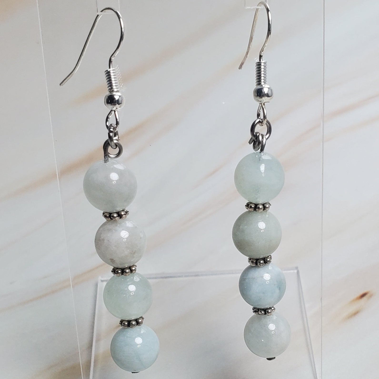 Pair of earrings with beads on a light background