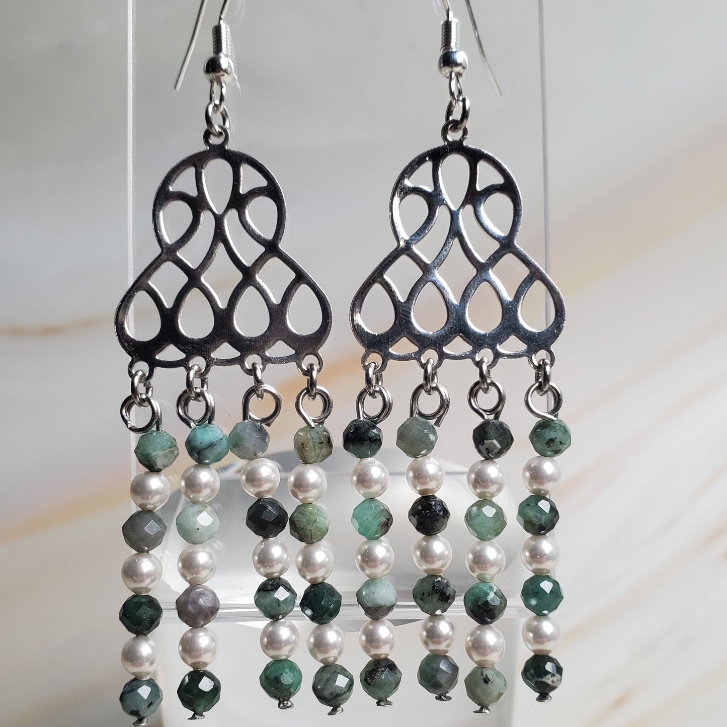 Pair of earrings with multicolored beads on a white background