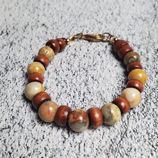 Beaded bracelet with multicolored stones on a textured gray surface