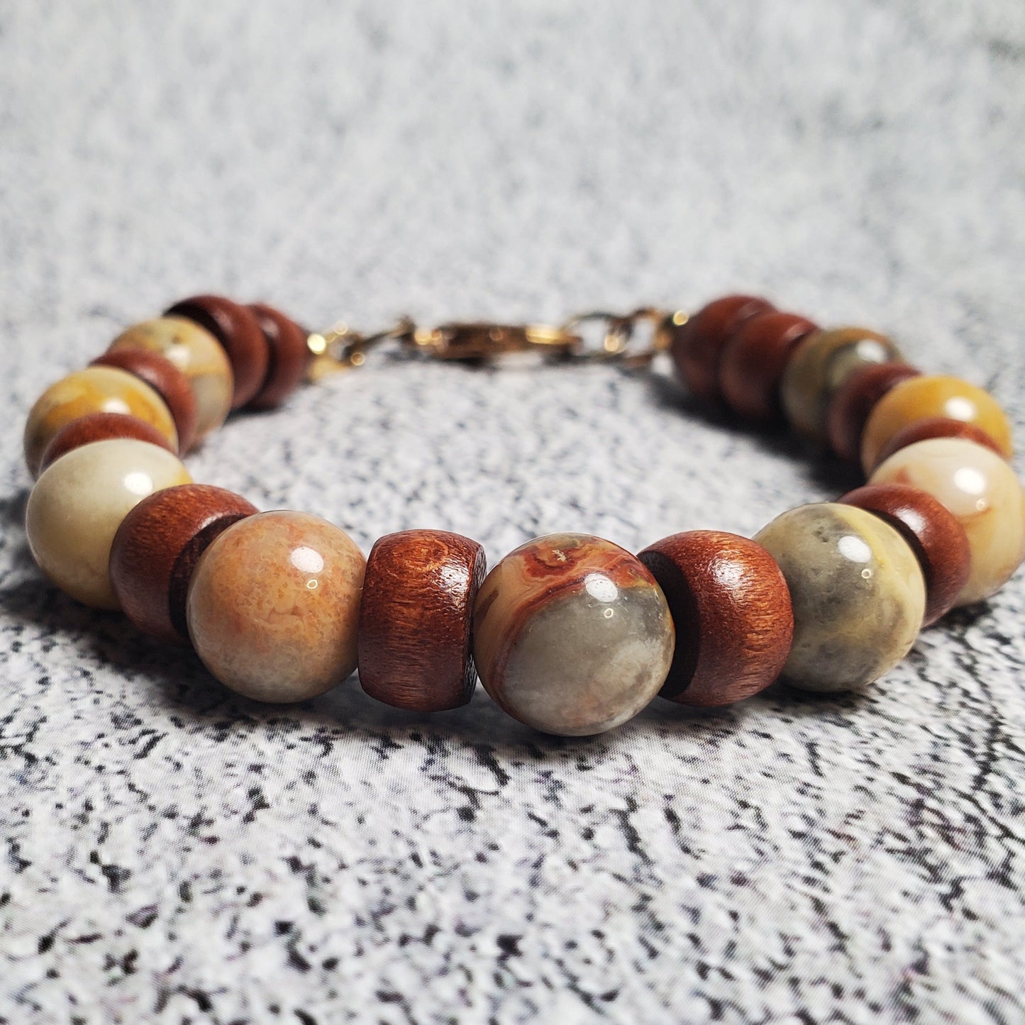 Beaded bracelet with multicolored beads on a textured surface