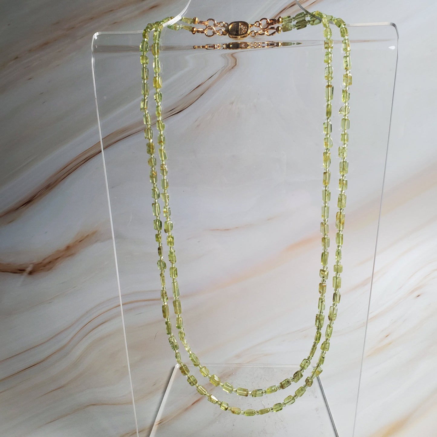 Double-strand peridot chip gemstone necklace with gold-tone clasp in vibrant green