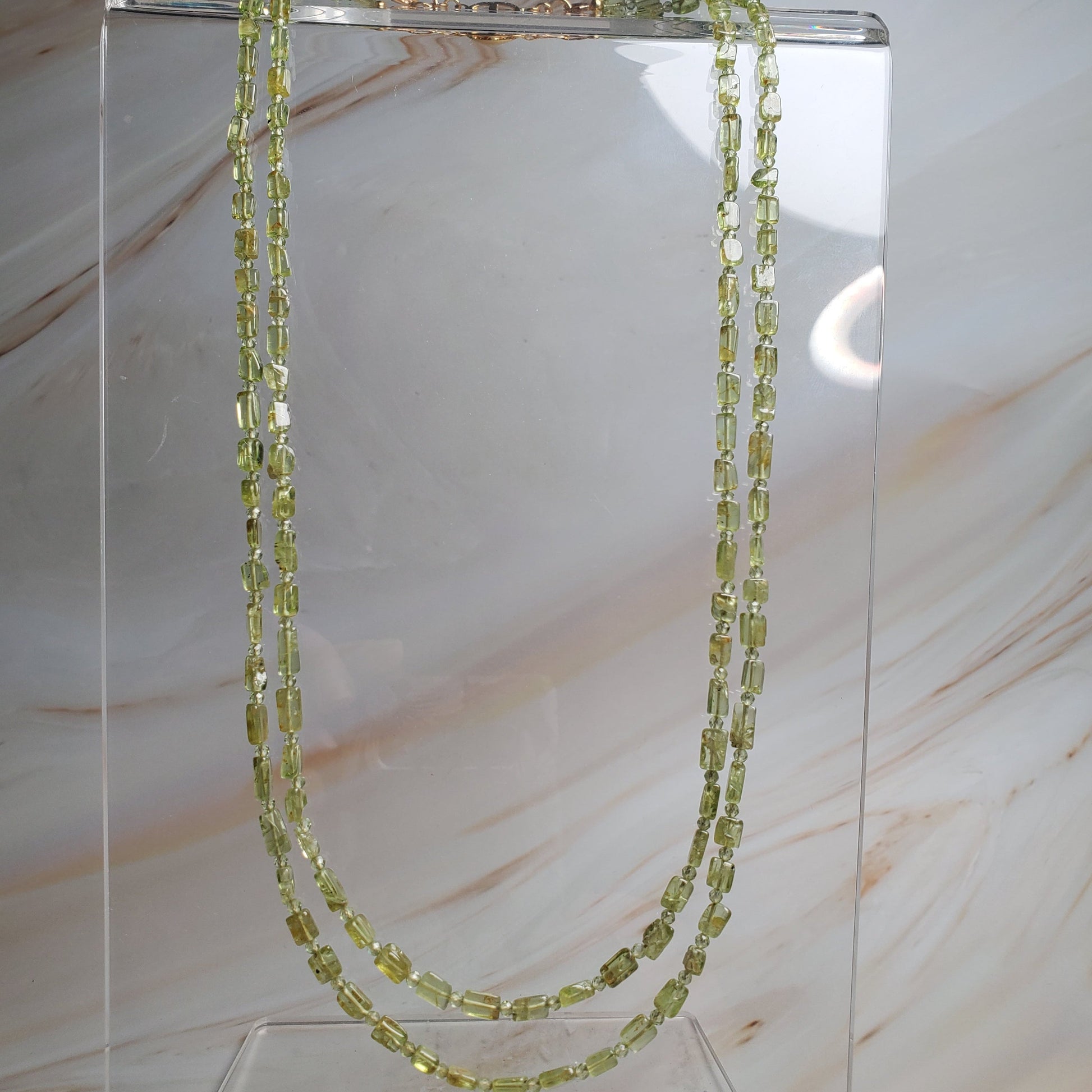 Double-strand gemstone necklace with peridot chips and round beads in vibrant green tones
