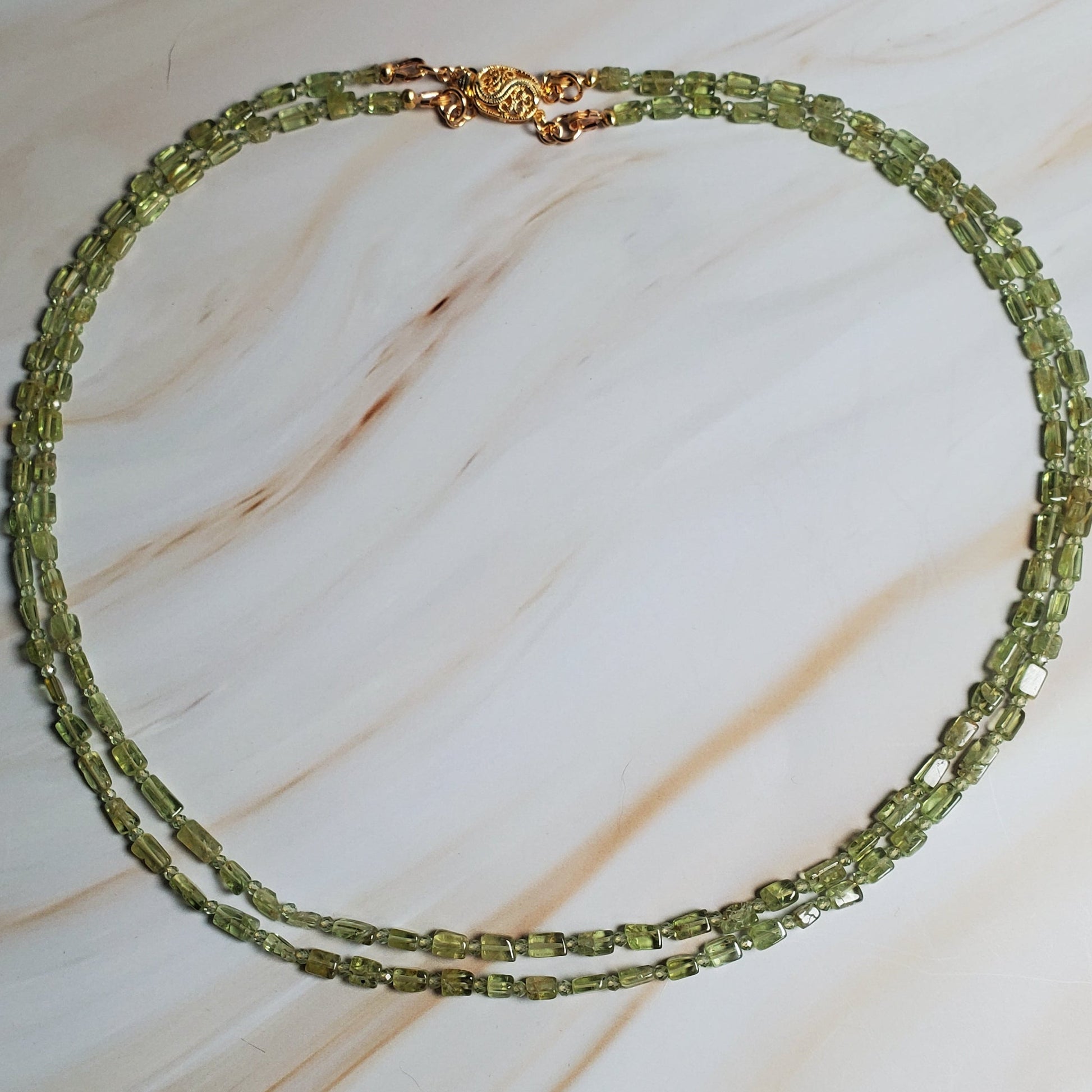 Double-strand gemstone necklace with peridot chips and gold-tone clasp