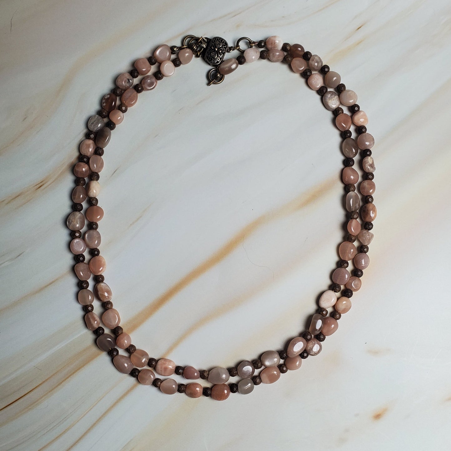 Beaded necklace on a marble surface
