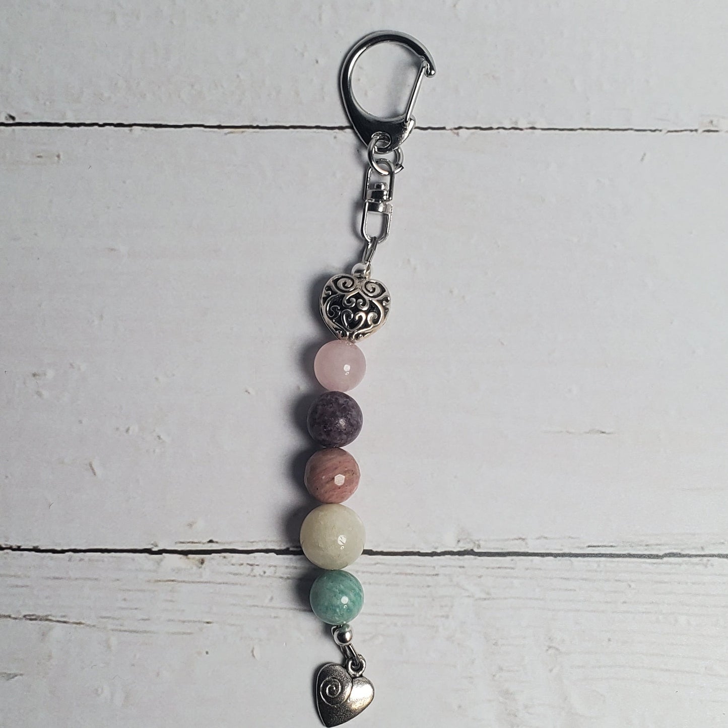 Beaded keychain with metal clasp on a light wooden surface